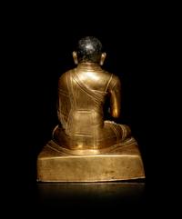A Large Sino-Tibetan Gilt Copper Repoussé Figure of a Seated Lama