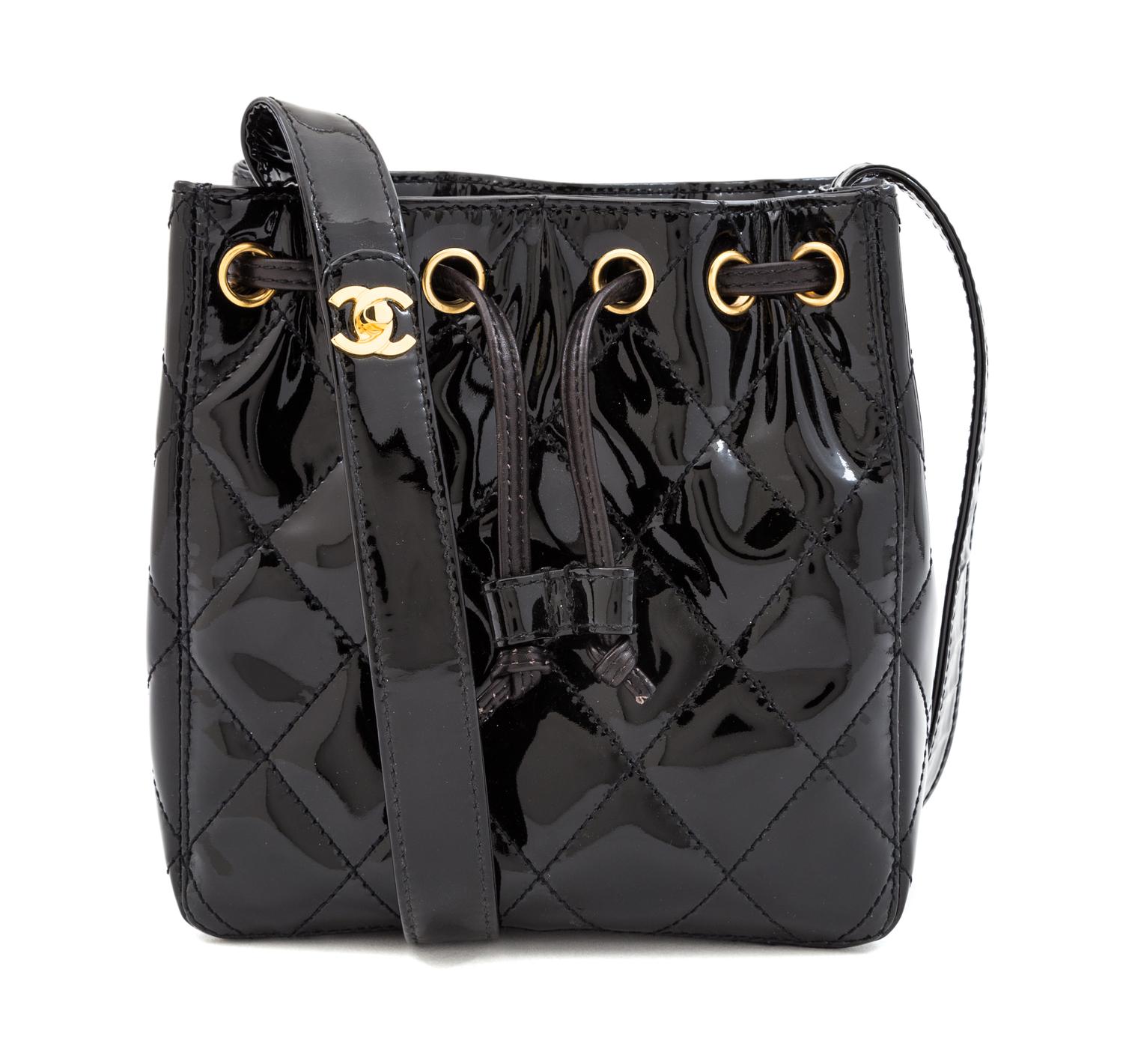 A Chanel Black Patent Leather Quilted Drawstring Bag, 7" x 7.25" x 3.25"; Strap drop: 18".
