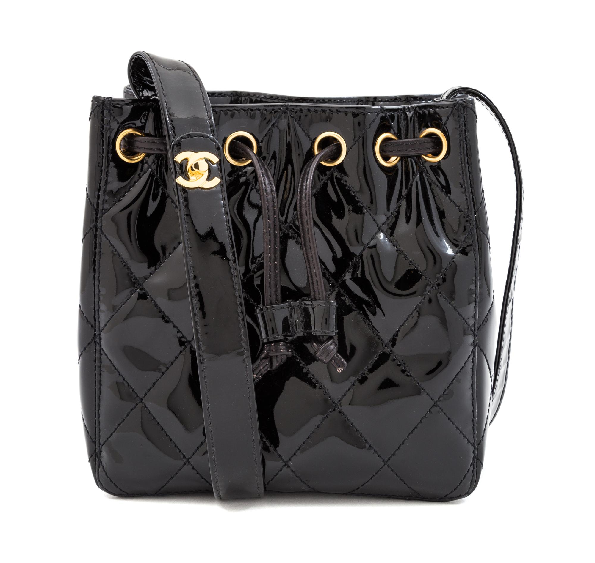 A Chanel Black Patent Leather Quilted Drawstring Bag, 7" x 7.25" x 3.25"; Strap drop: 18".