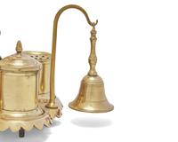 A Group of Ten Brass Candlesticks and a Brass Standish