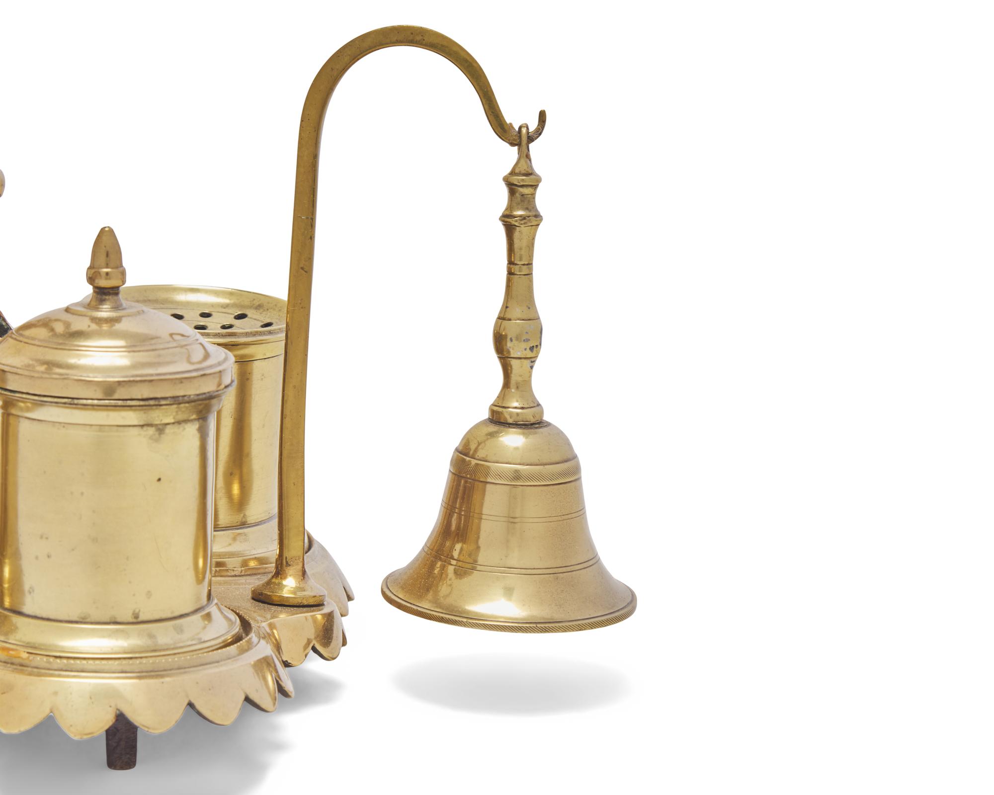 A Group of Ten Brass Candlesticks and a Brass Standish