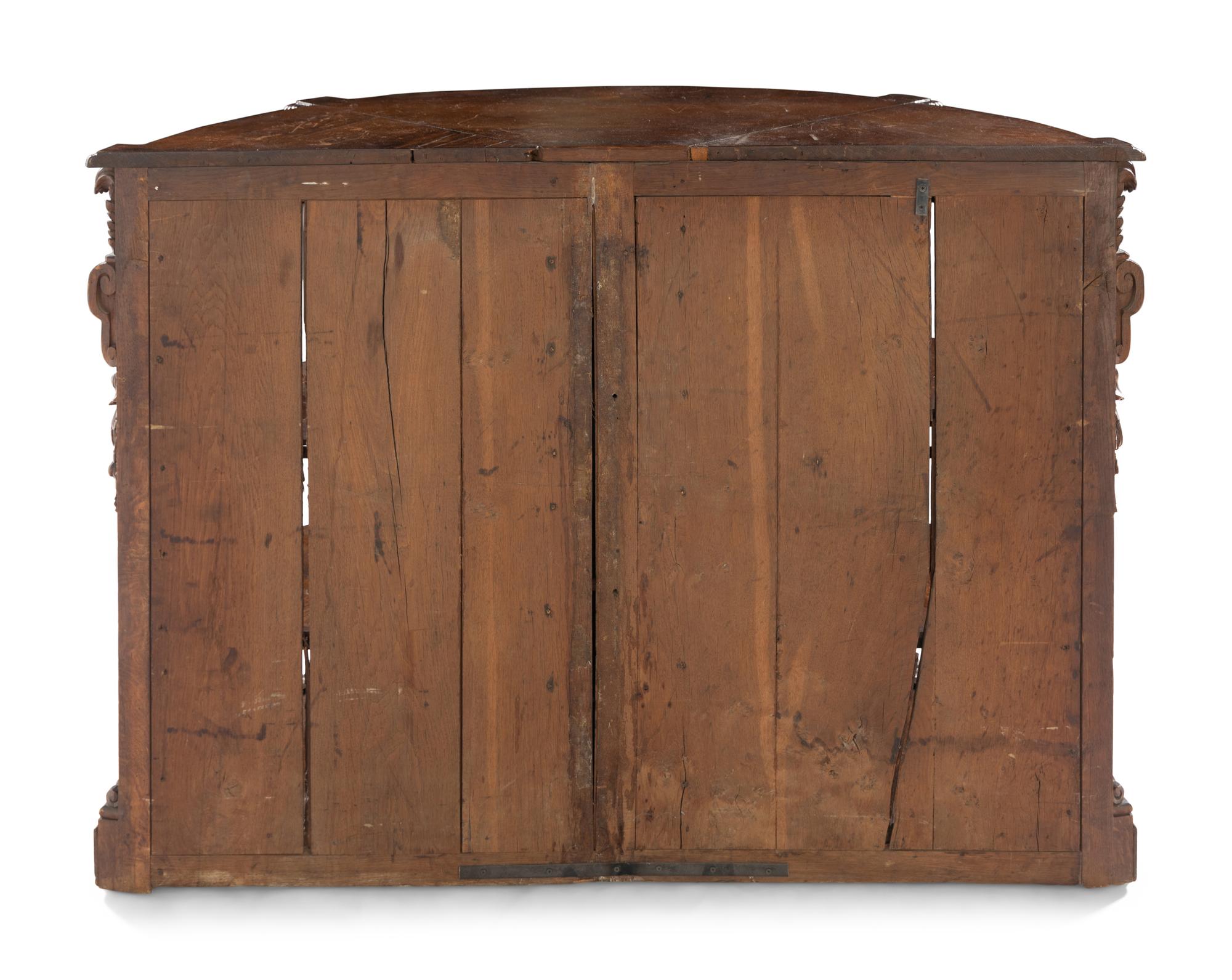 A Continental Carved Oak Demilune Cabinet