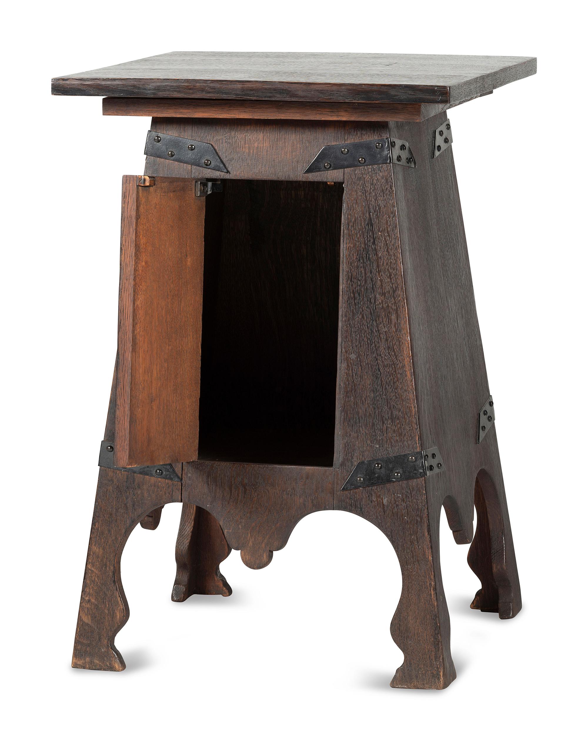 An Arts and Crafts Carved Oak Wine Cellarette