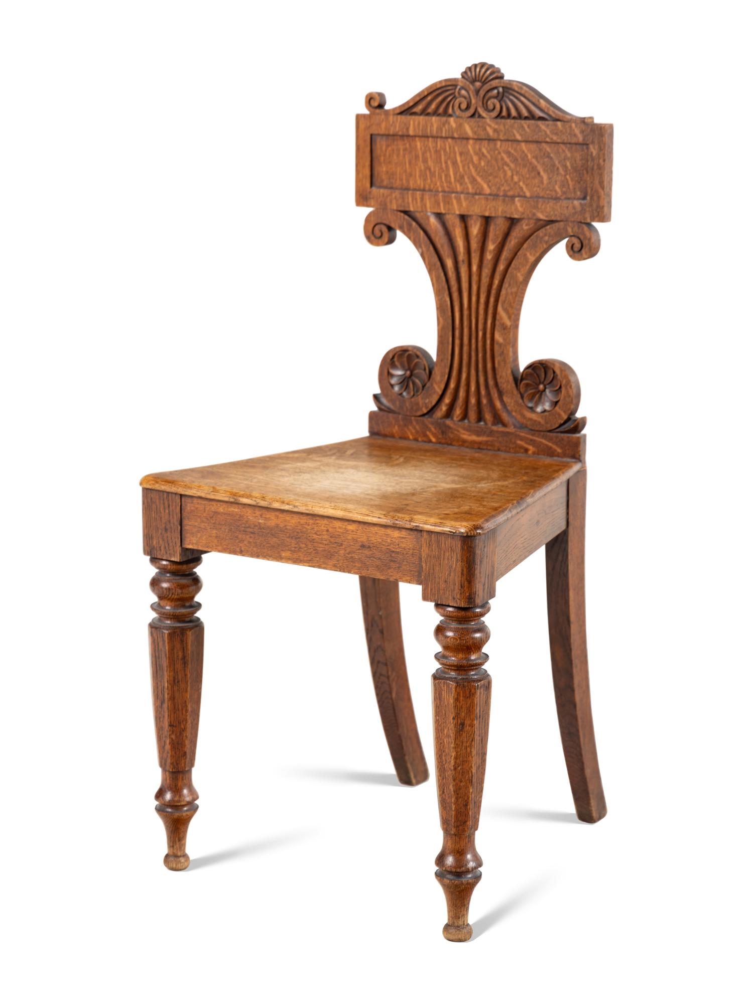 A Pair of William IV Carved Oak Hall Chairs