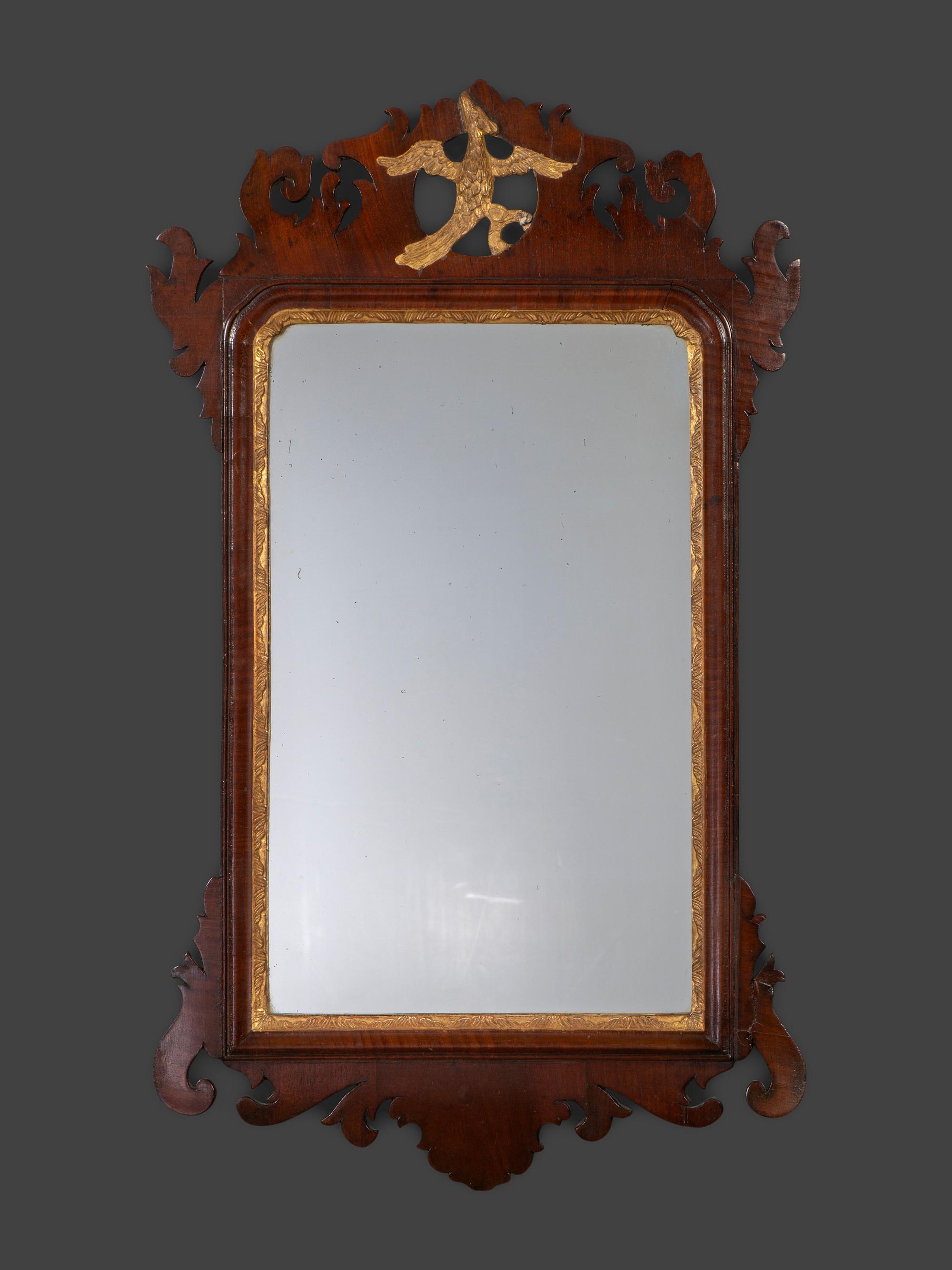 A Chippendale Carved and Parcel Gilt Mahogany Eagle-Decorated Looking Glass