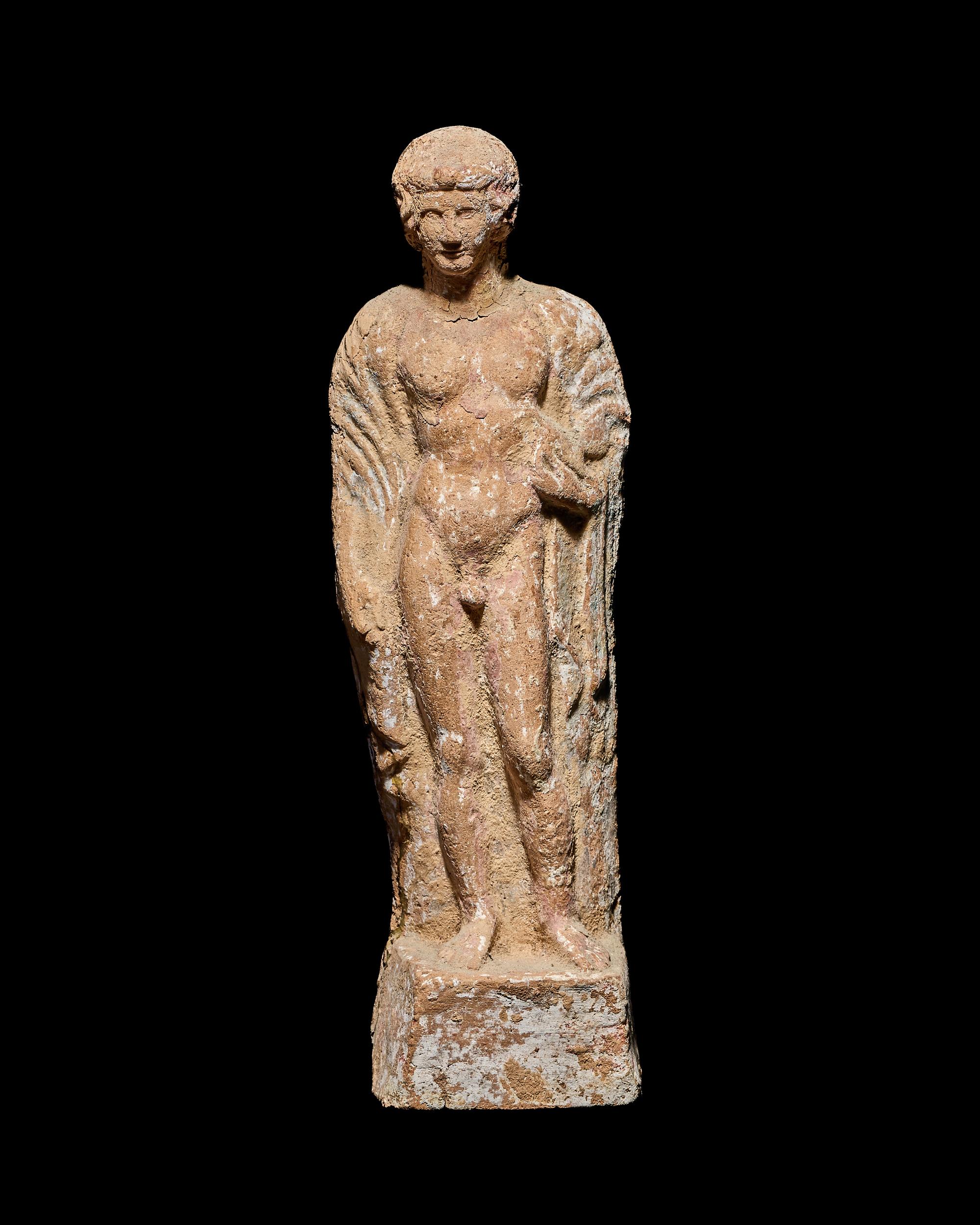 A Boeotian Terracotta Standing Youth with a Cock