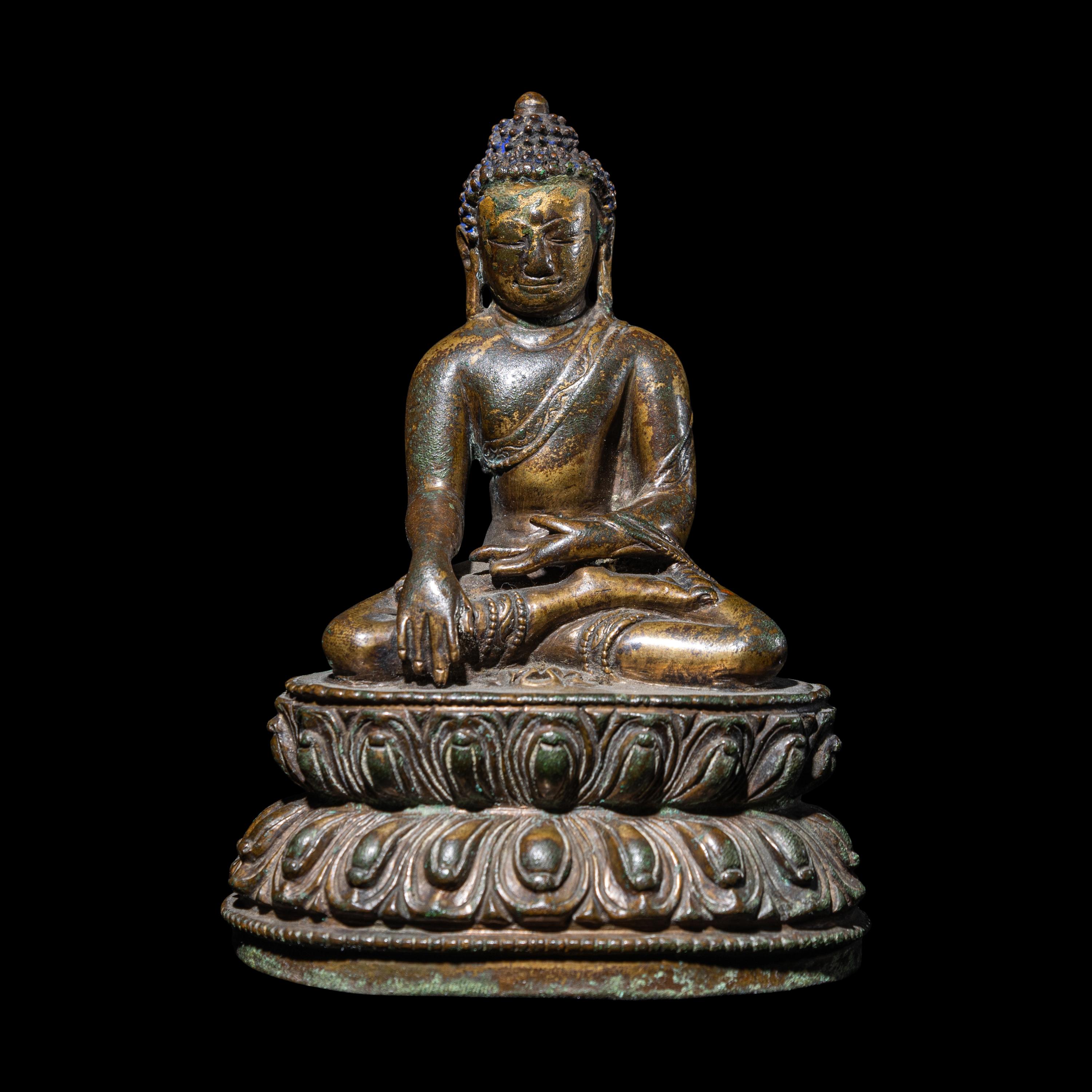 A Tibetan Gilt Copper Alloy Figure of Buddha Shakyamuni, 14th/15th Century 十四/十五世紀 西藏銅鎏金坐佛