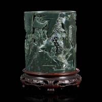 A Chinese carved dark green hardstone brushpot with marble-inlaid wood stand