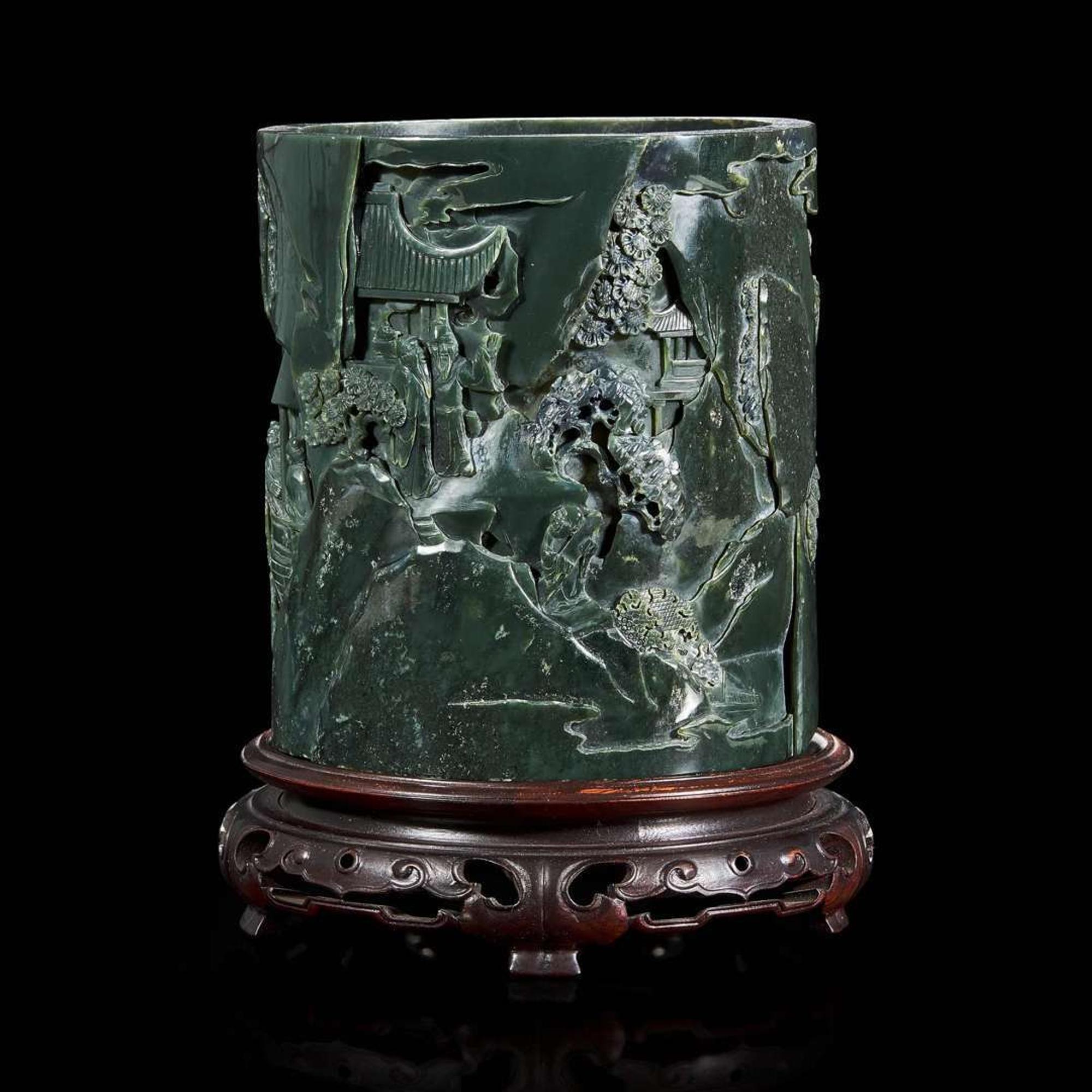 A Chinese carved dark green hardstone brushpot with marble-inlaid wood stand