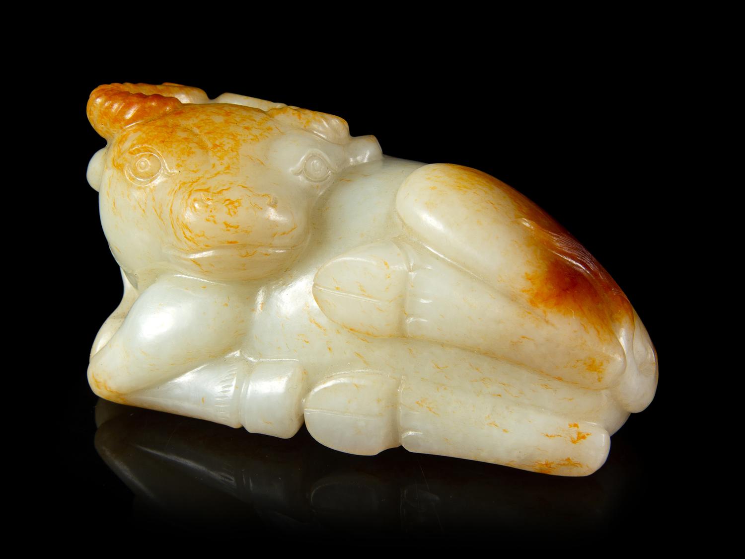 A Russet and White Jade Figure of a Buffalo