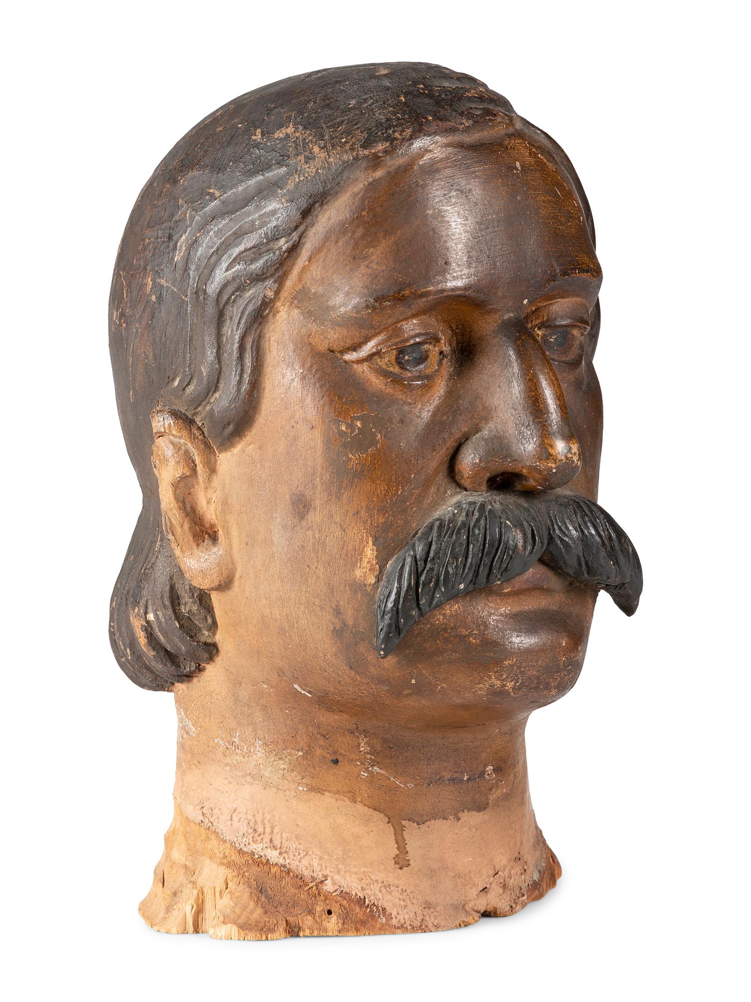 A Carved and Painted Wood Head of a Mustachioed Man