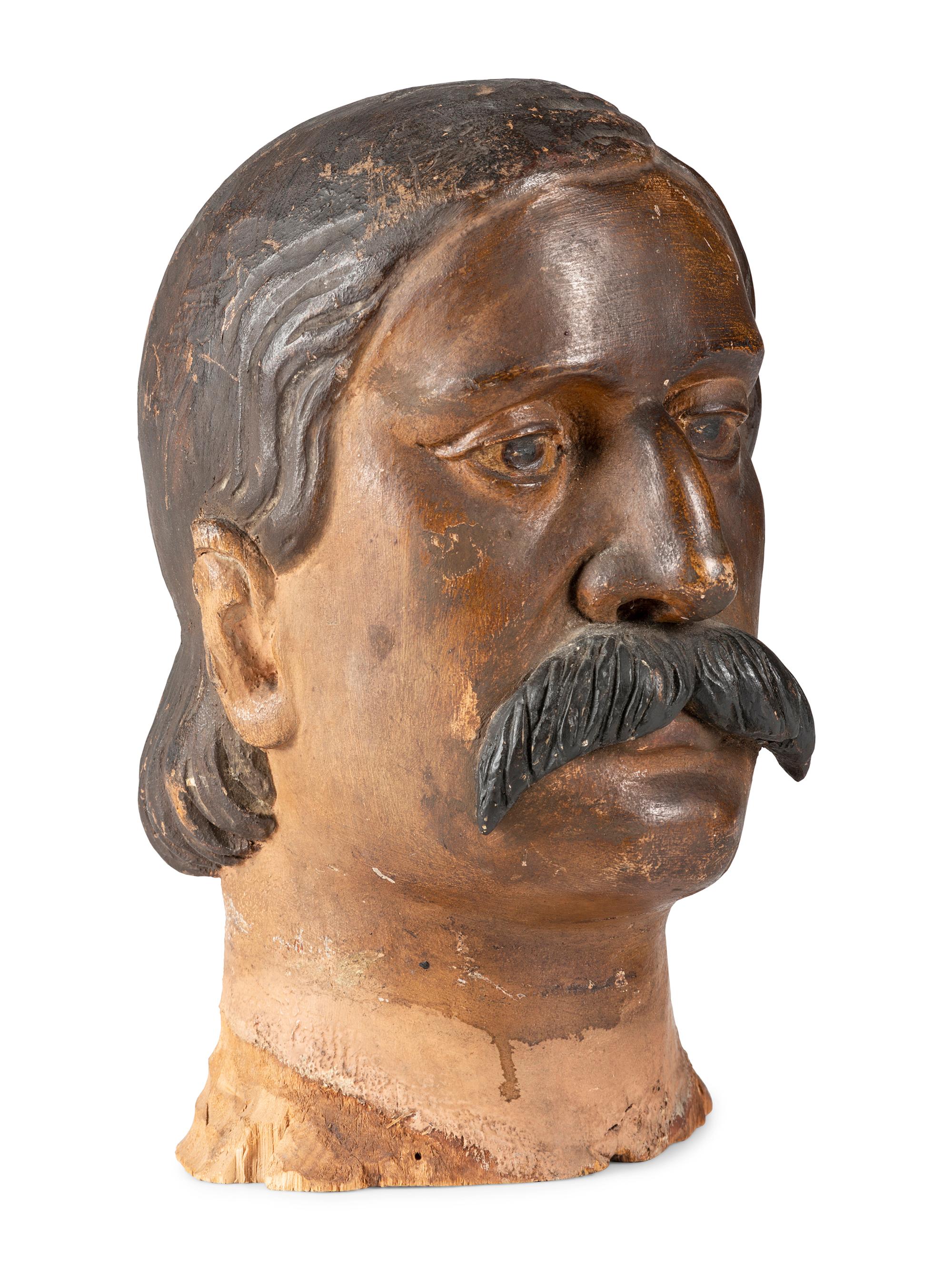 A Carved and Painted Wood Head of a Mustachioed Man