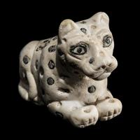 A Mesopotamian Marble and Lapis Lazuli Recumbent Leopard