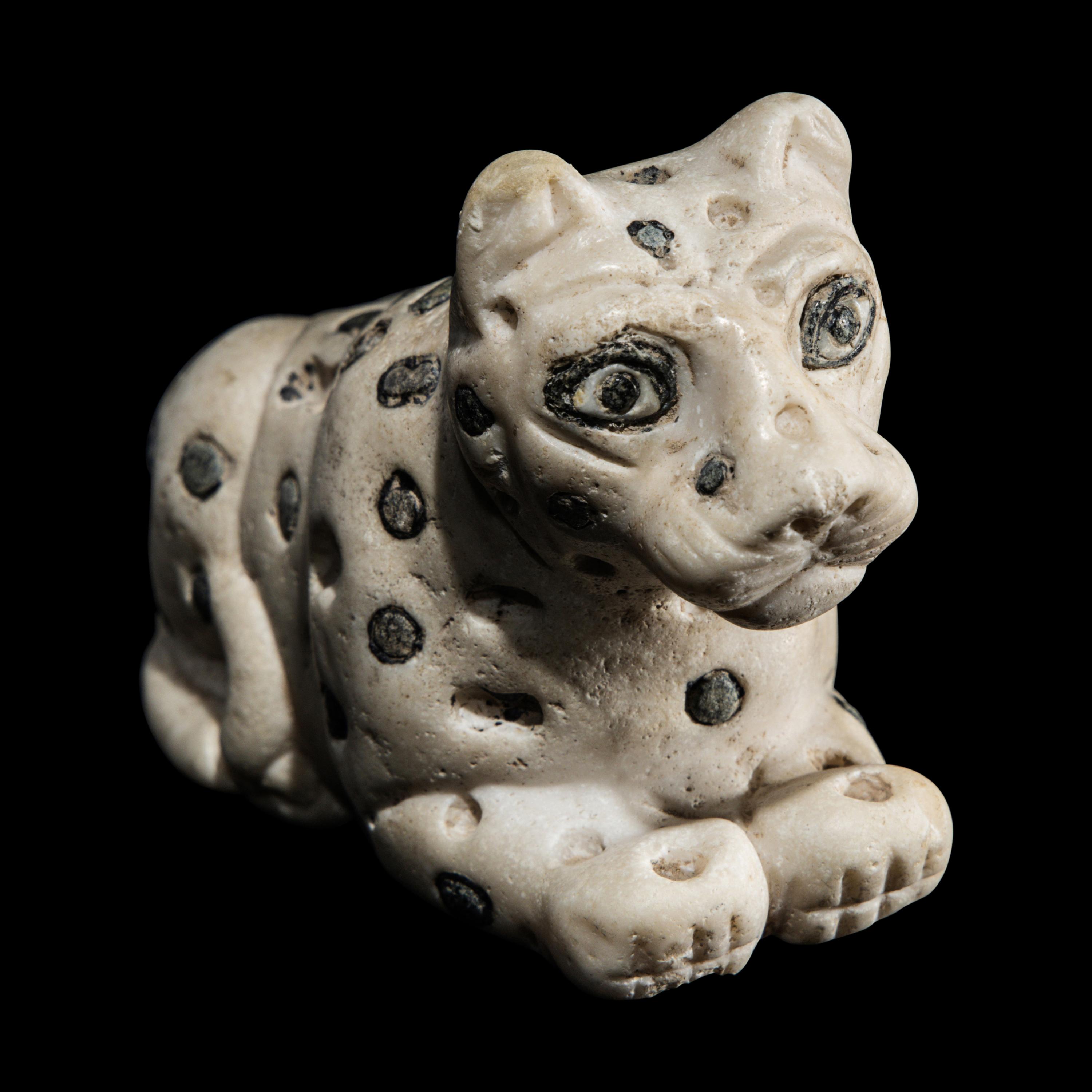 A Mesopotamian Marble and Lapis Lazuli Recumbent Leopard