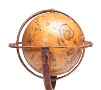 A Folk Art Painted Leather Covered Tabletop Globe
