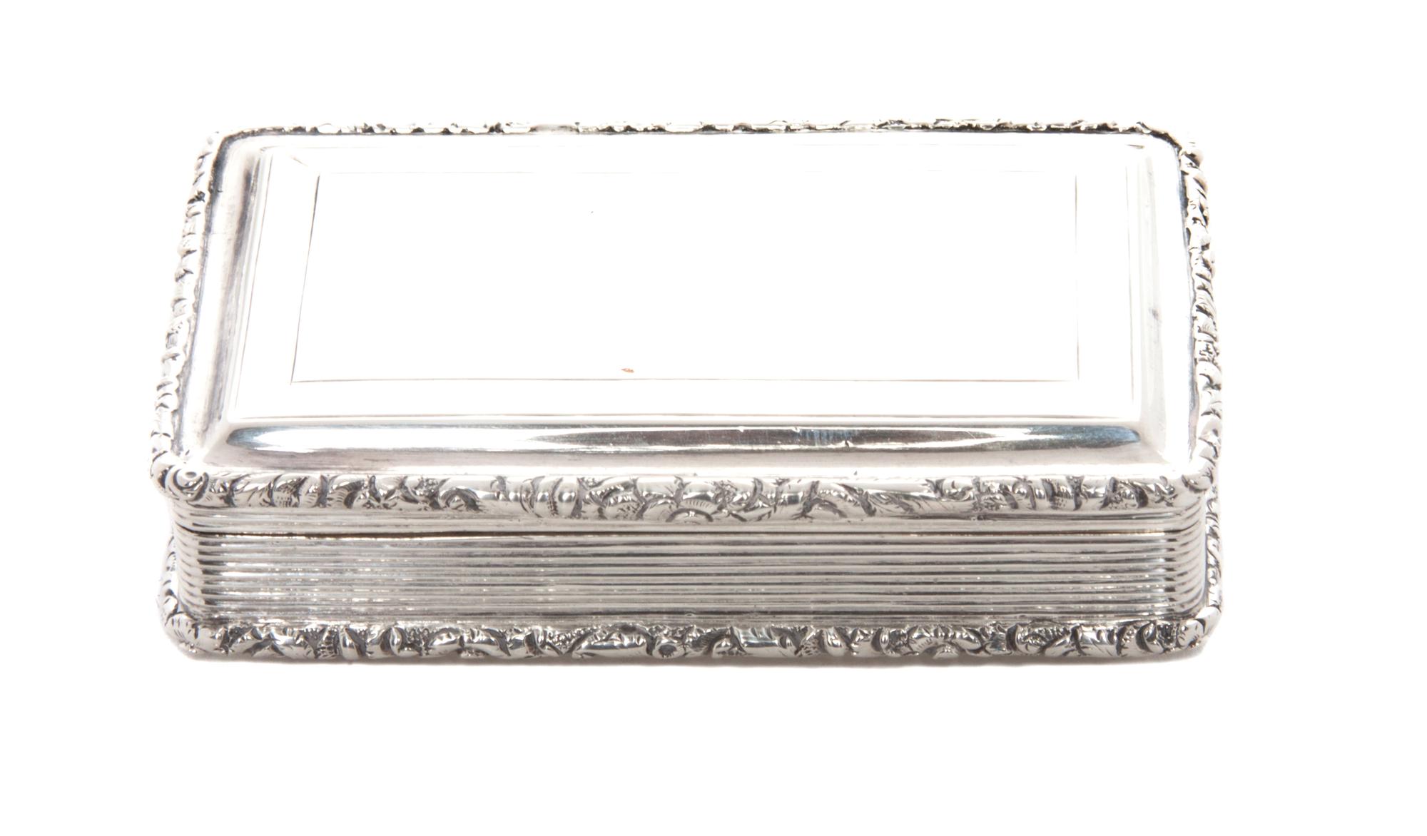 A Victorian Silver Snuff Box, Nathaniel Mills, Sheffield, Mid-19th Century, rectangular form with applied foliate borders and an engine