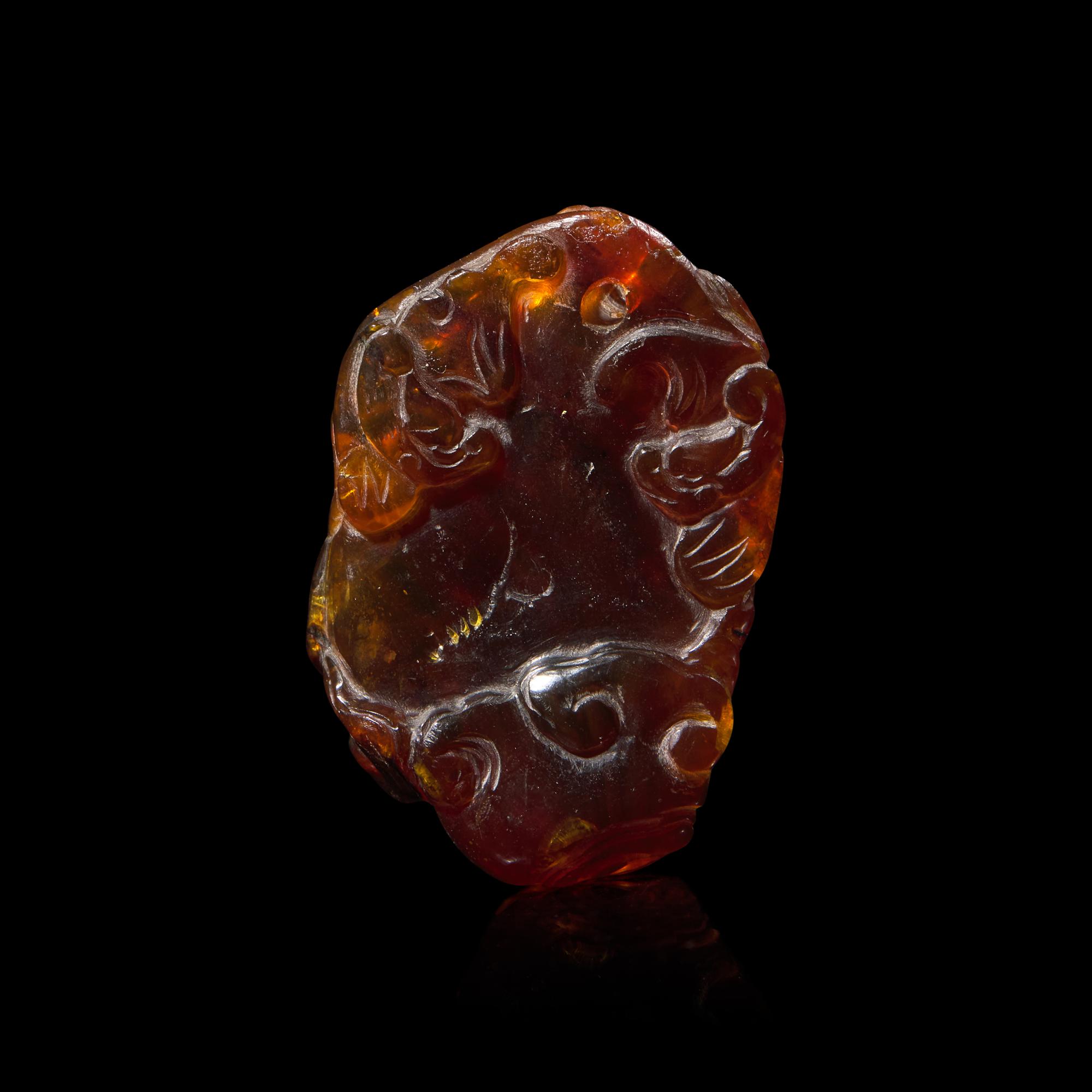 A Chinese Carved 'Bats and Shou-Lao' Amber Pendant, 18th-19th Century 清中期 五福捧壽琥珀把件