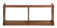 A Cherry and Brass Mounted Cane Stand, Height 28 1/2 x width 68 x depth 8 1/2 inches.