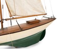 A Carved Wood and Linen Pond Boat