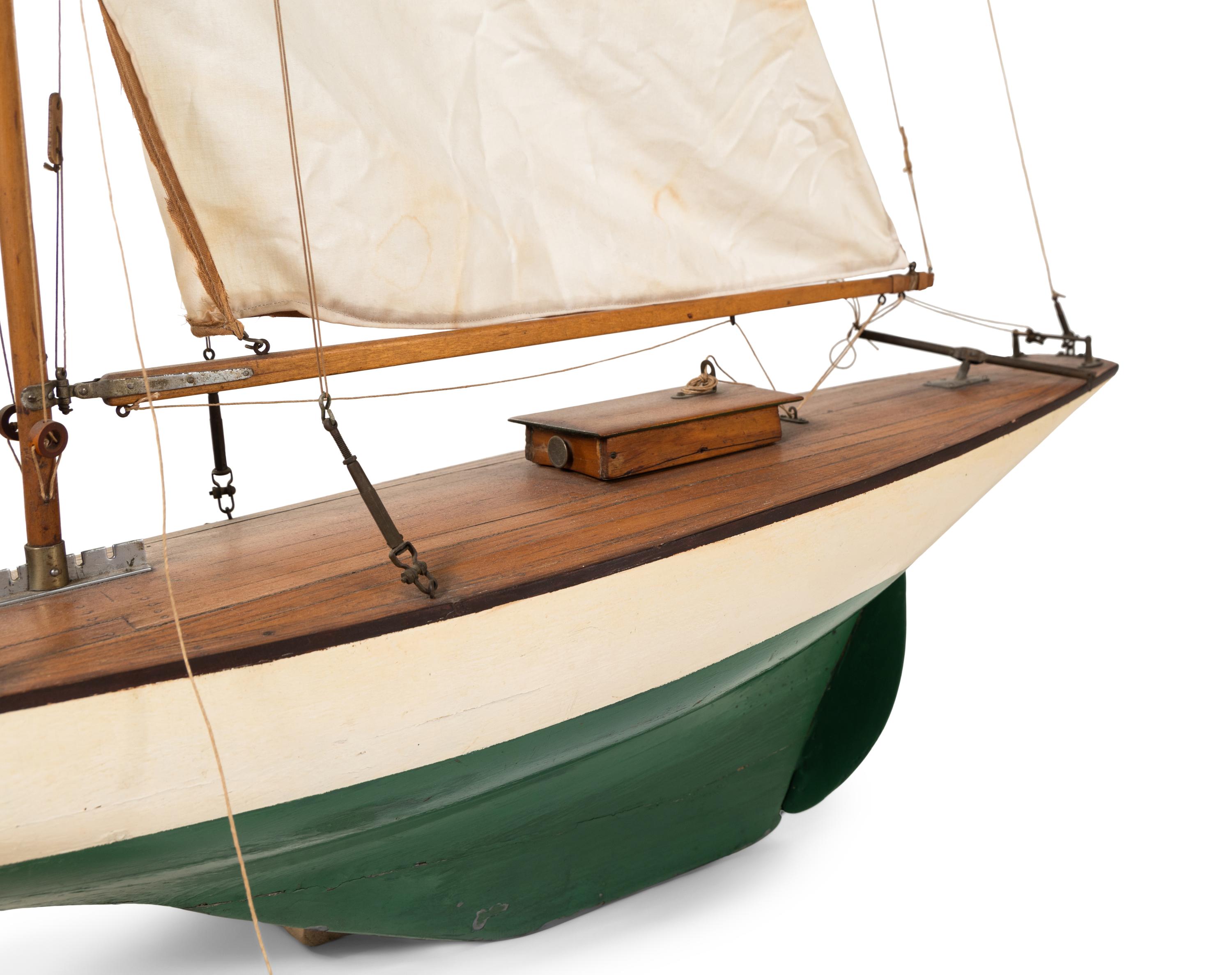 A Carved Wood and Linen Pond Boat