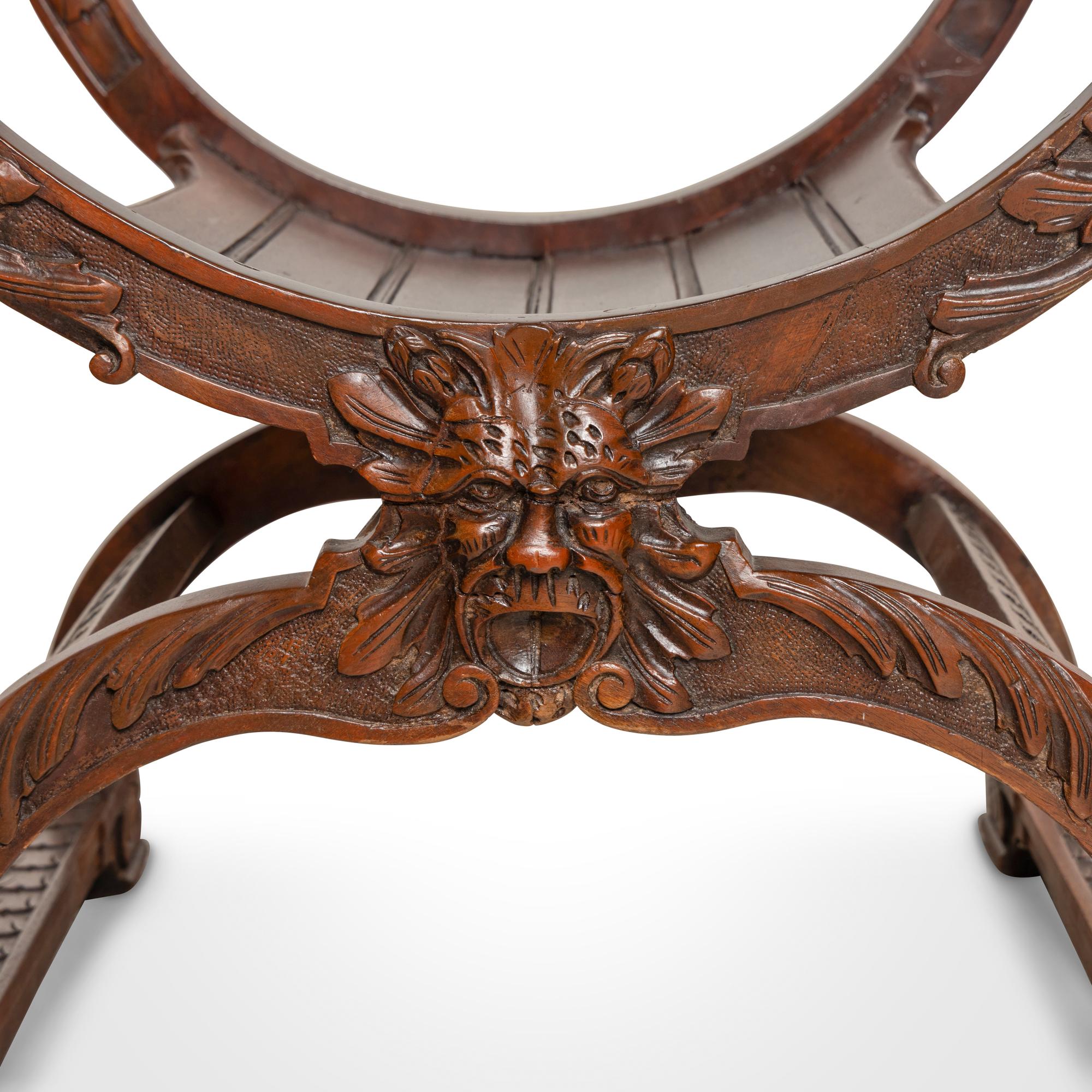 A Pair of Italian Carved Walnut Savonarola Chairs