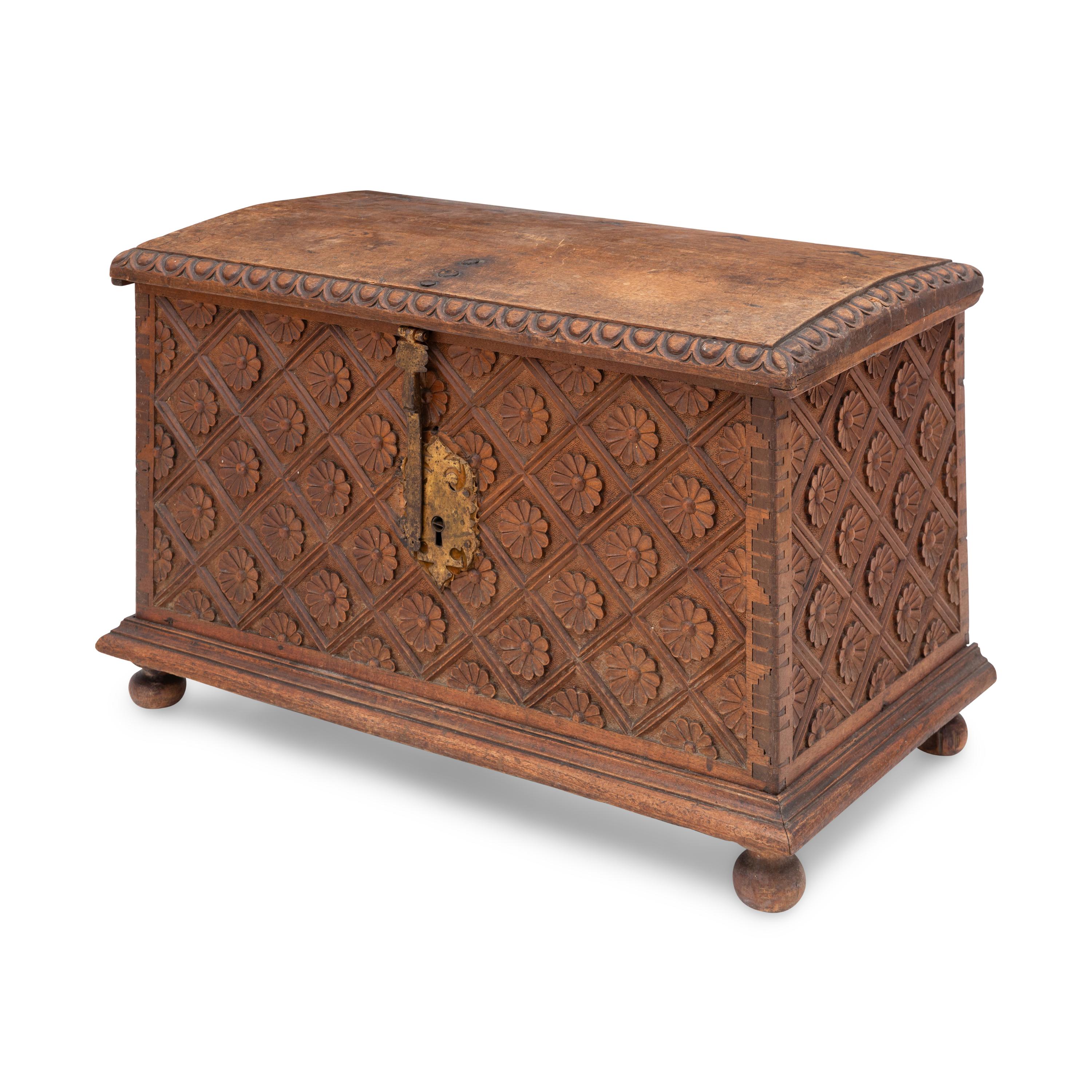 A Spanish Carved Walnut and Gilt Iron Chest