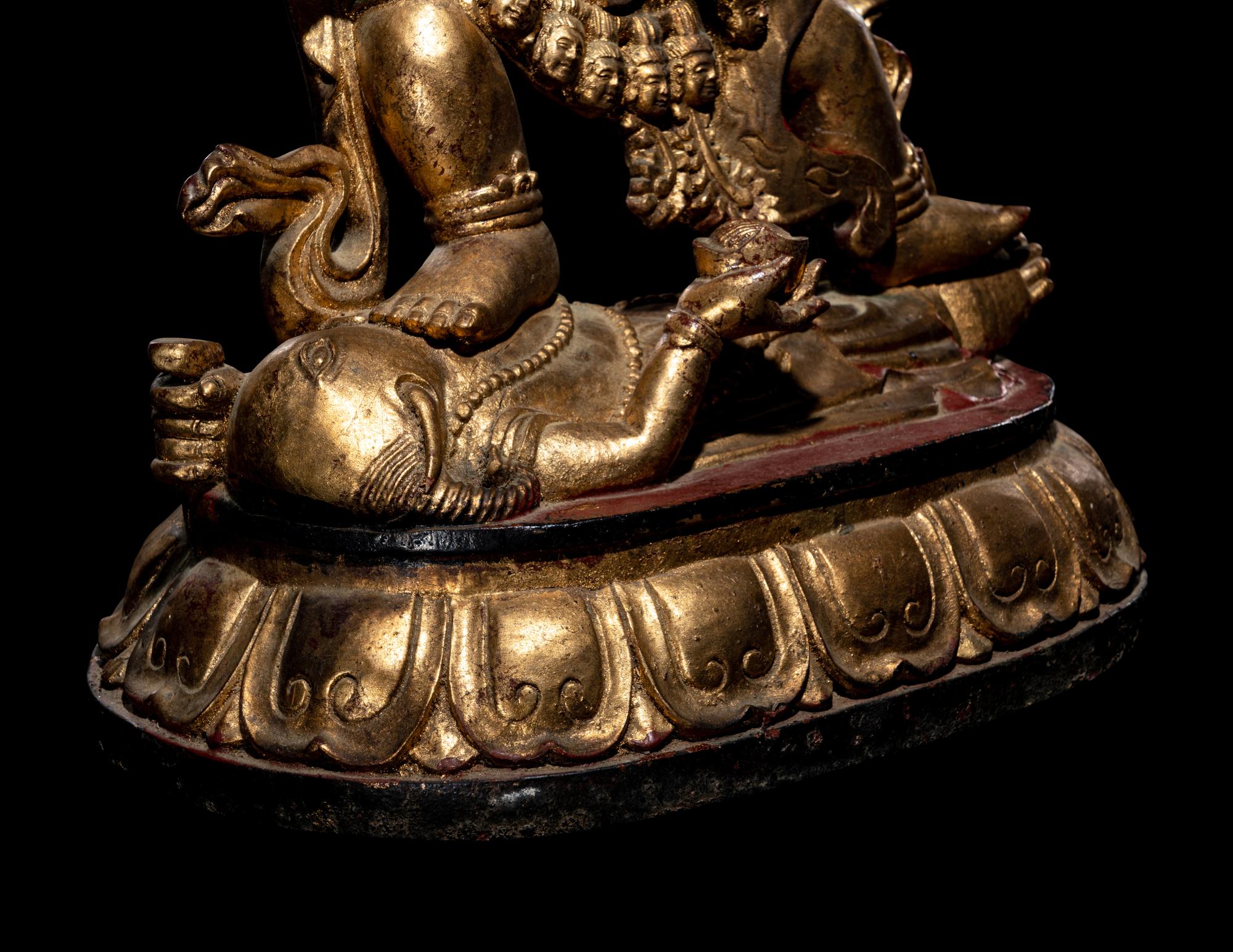 A Large Sino-Tibetan Gilt and Red Lacquered Wood Figure of a Mahākāla