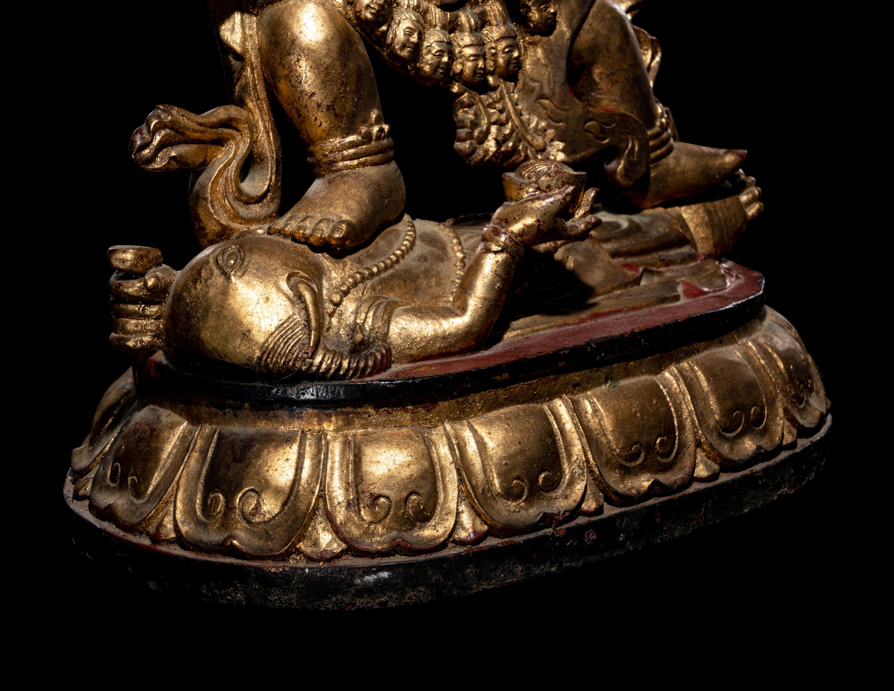 A Large Sino-Tibetan Gilt and Red Lacquered Wood Figure of a Mahākāla