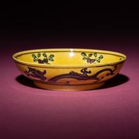 A Small Chinese Yellow Ground Green and Aubergine 'Dragon' Dish, Daoguang Mark and Period — 清道光 黃地紫綠彩雙龍戲珠紋碟