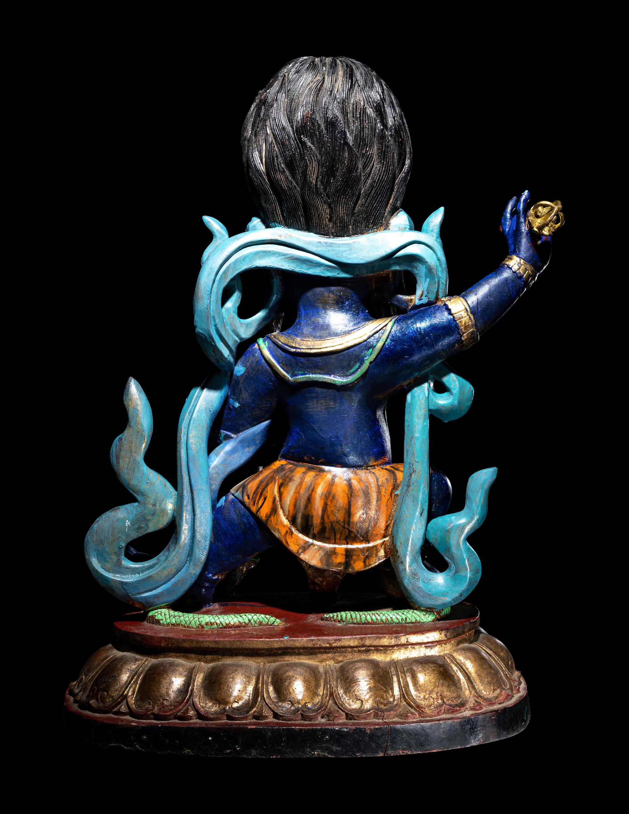 A Large Tibetan Polychrome Painted Wood Figure of a Mahākāla