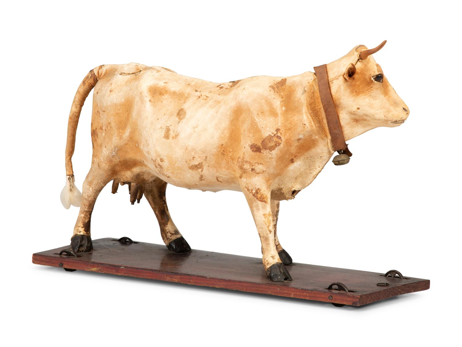 A Wood and Leather Mooing Cow-Form Pull Toy