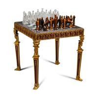 An Empire Style Gilt Bronze Mounted Mahogany and Marble-Top Game Table with a Rock Crystal and Tiger's Eye Chess Set