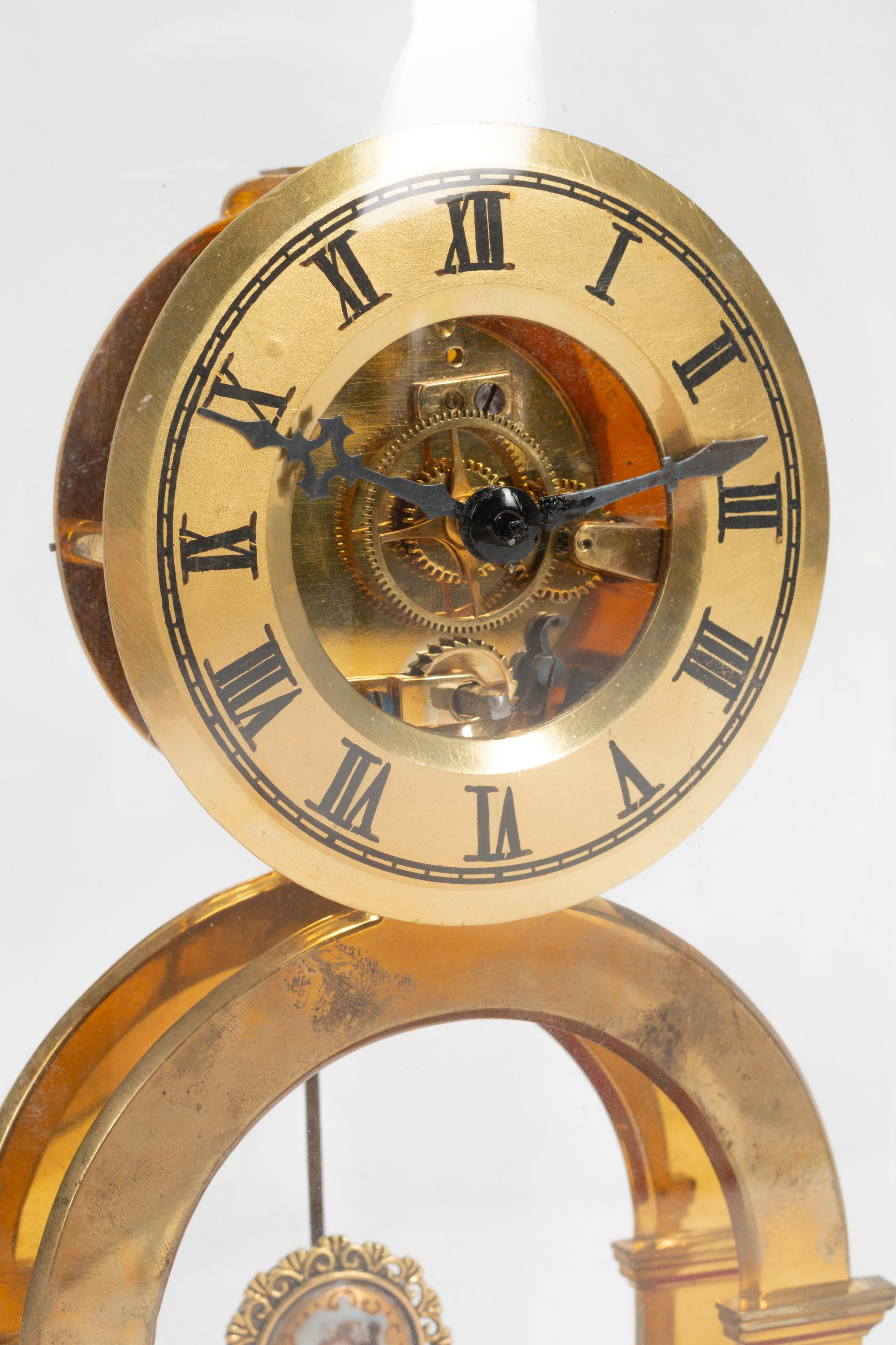 A Continental Gilt Bronze Skeleton Clock and Glass Dome
