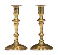 A Pair of Queen Anne Brass Petal Base Candlesticks