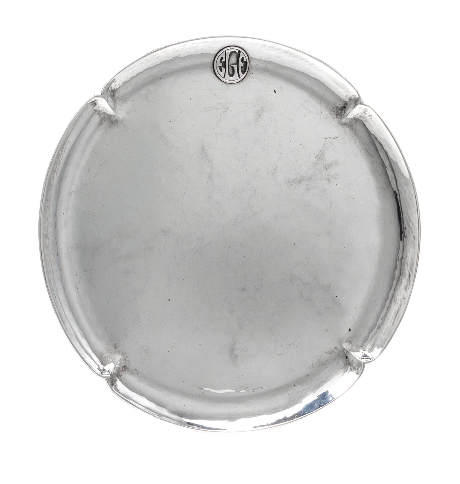 An American Arts and Crafts Silver Tray, The Art Silver Shop, Chicago, IL, of circular form with a notched rim having an applied EGF ci