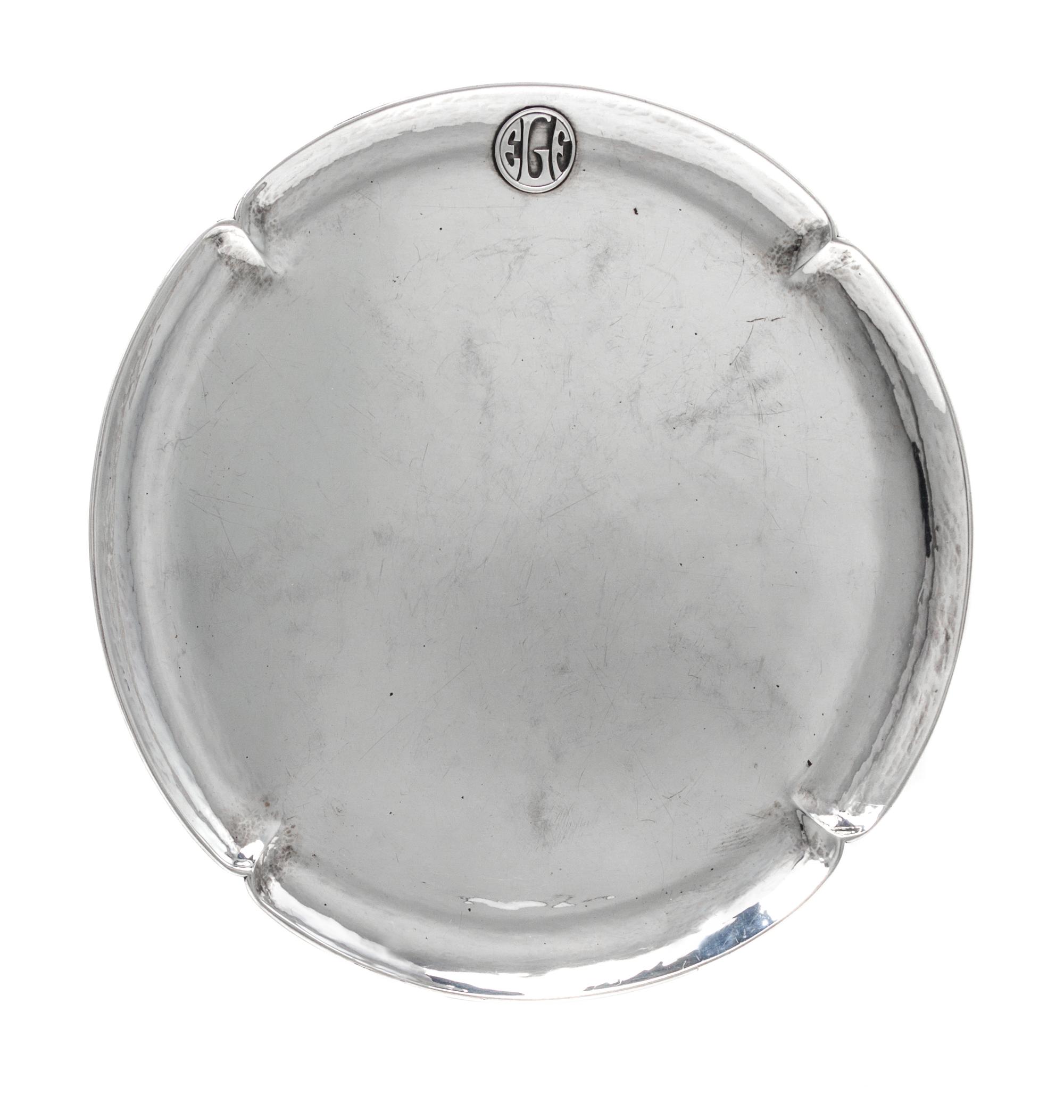 An American Arts and Crafts Silver Tray, The Art Silver Shop, Chicago, IL, of circular form with a notched rim having an applied EGF ci