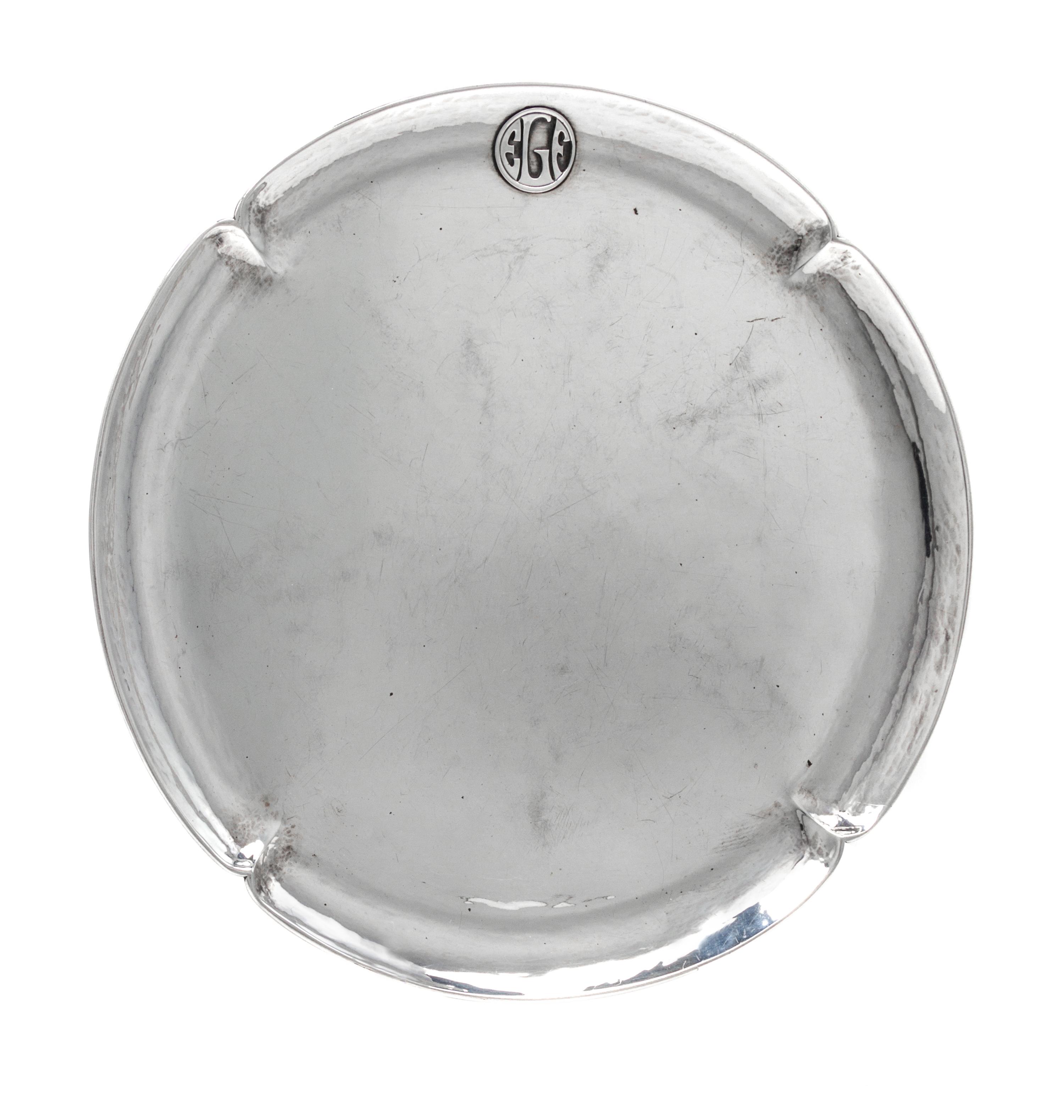 An American Arts and Crafts Silver Tray, The Art Silver Shop, Chicago, IL, of circular form with a notched rim having an applied EGF ci