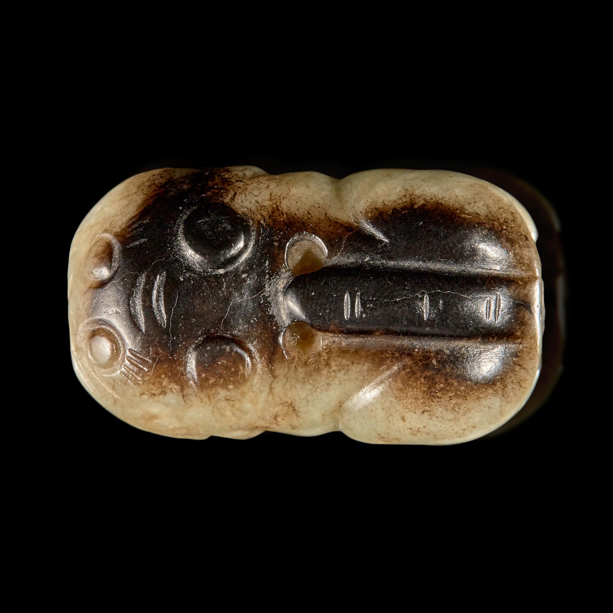 A Small Chinese Black and Celadon-Grey Jade Cat, Ming Dynasty 明 灰褐玉卧貓