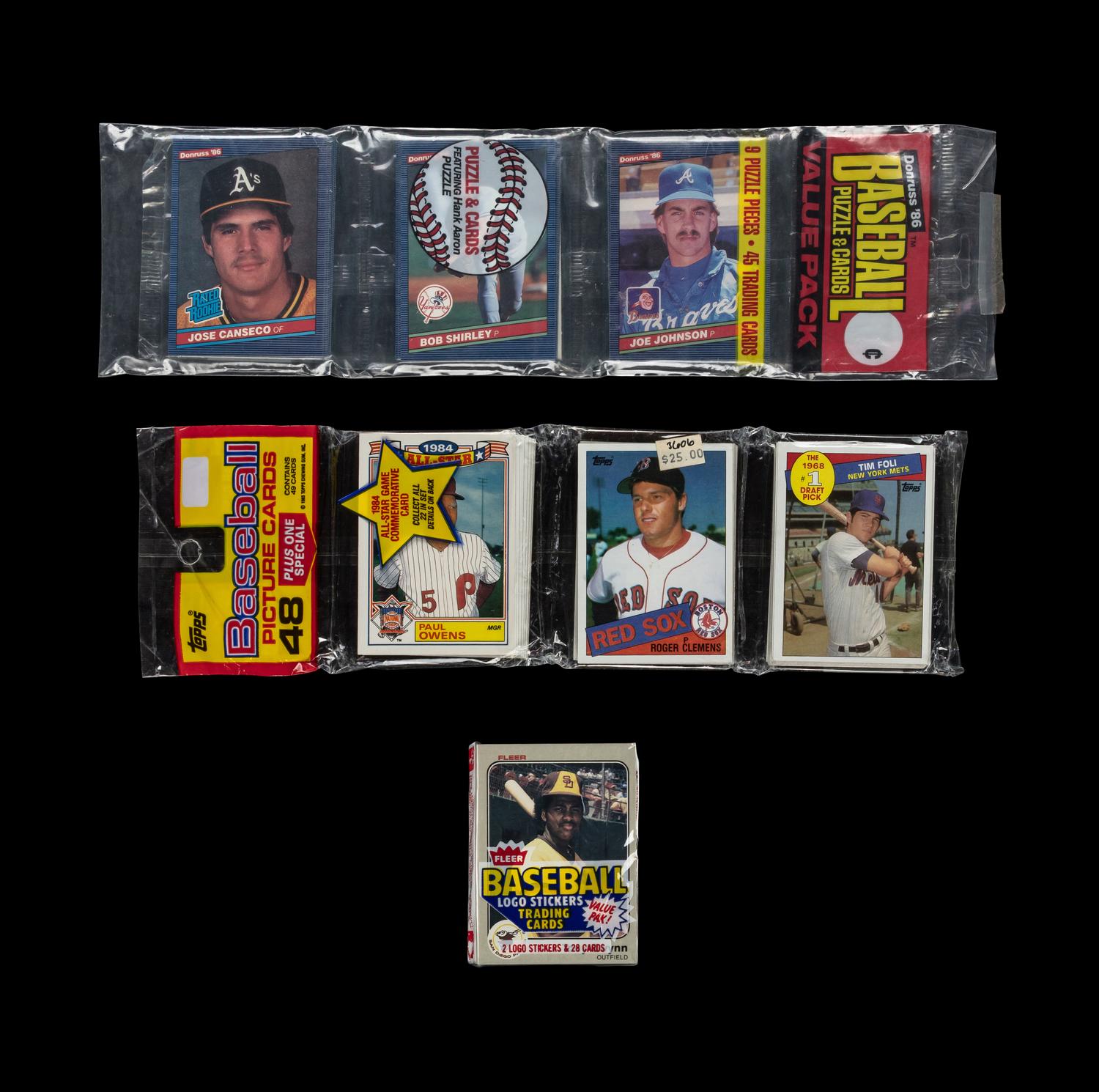 A Collection of 1980s Unopened Baseball Card Packs with Notable Rookie Cards Visible