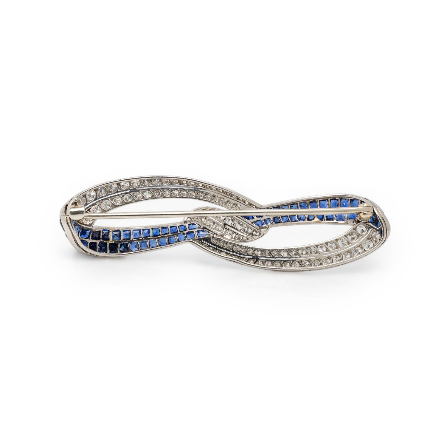 PLATINUM, DIAMOND, AND SAPPHIRE BOW BROOCH