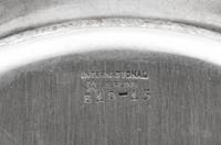 A Set of Sixteen American Silver Bread Plates