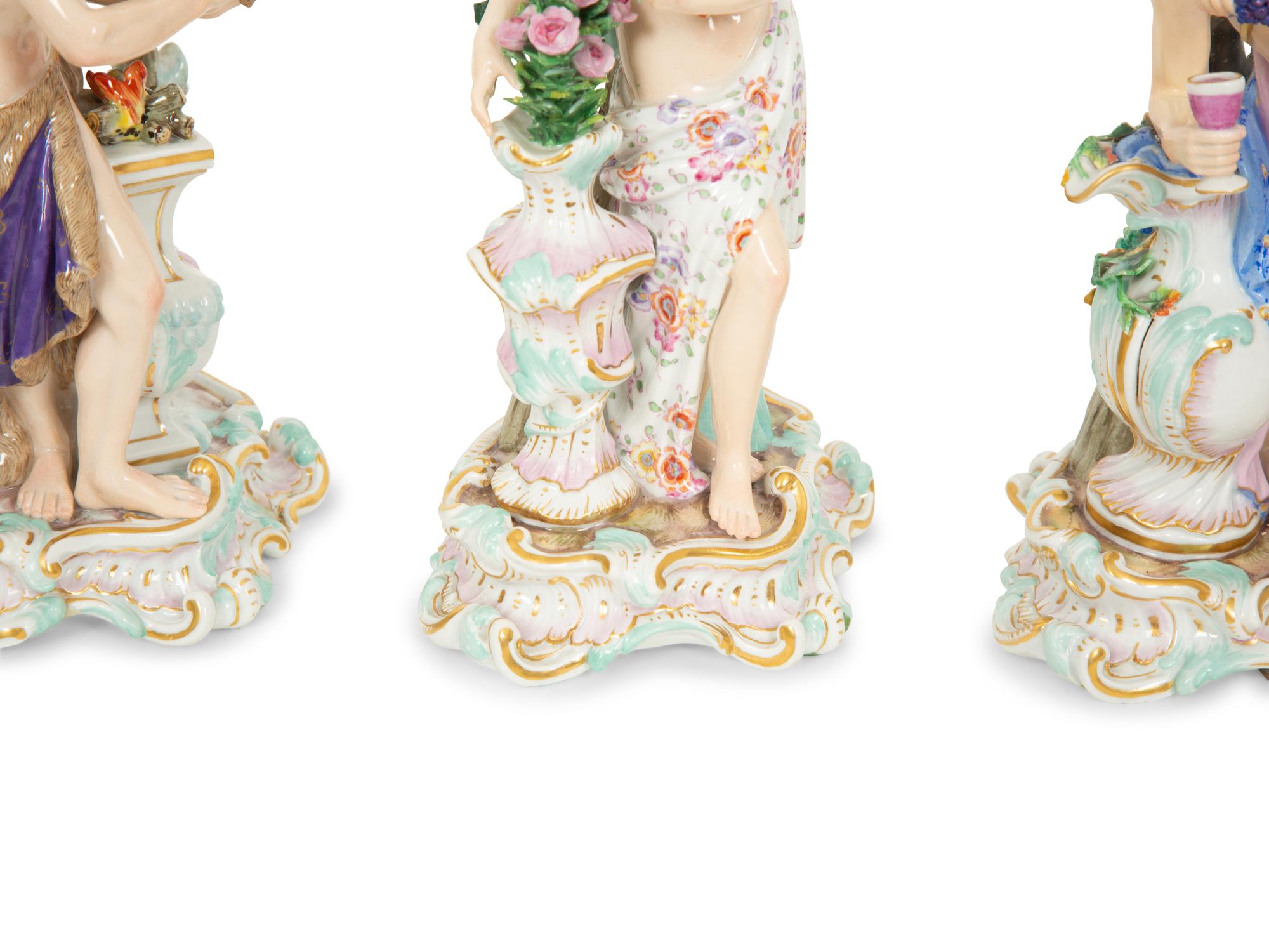 A Set of Meissen Porcelain Four Seasons Candlesticks