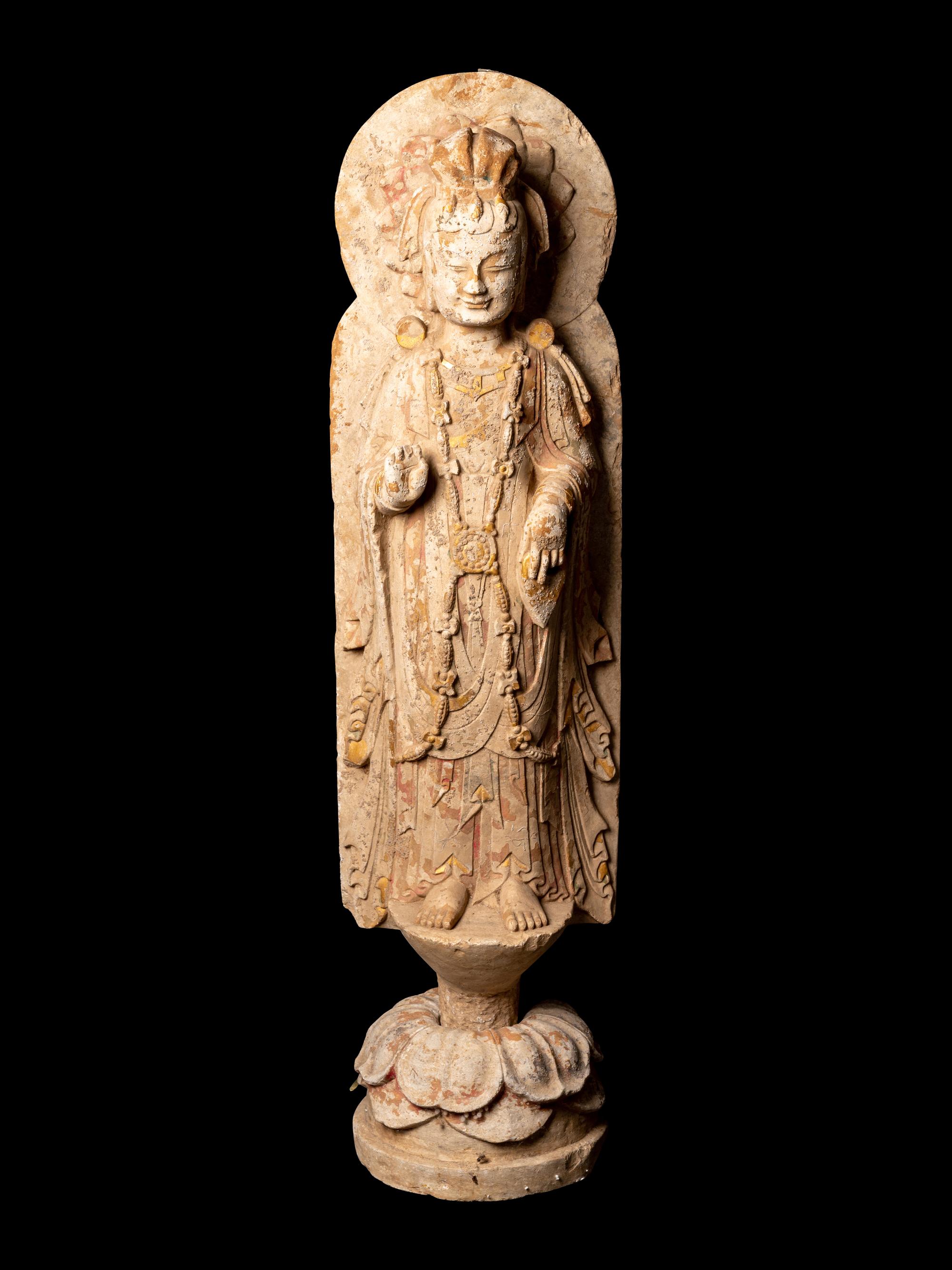 A Chinese Carved Stone Standing Buddha with Remnants of Gilt on Lotus-Form Base