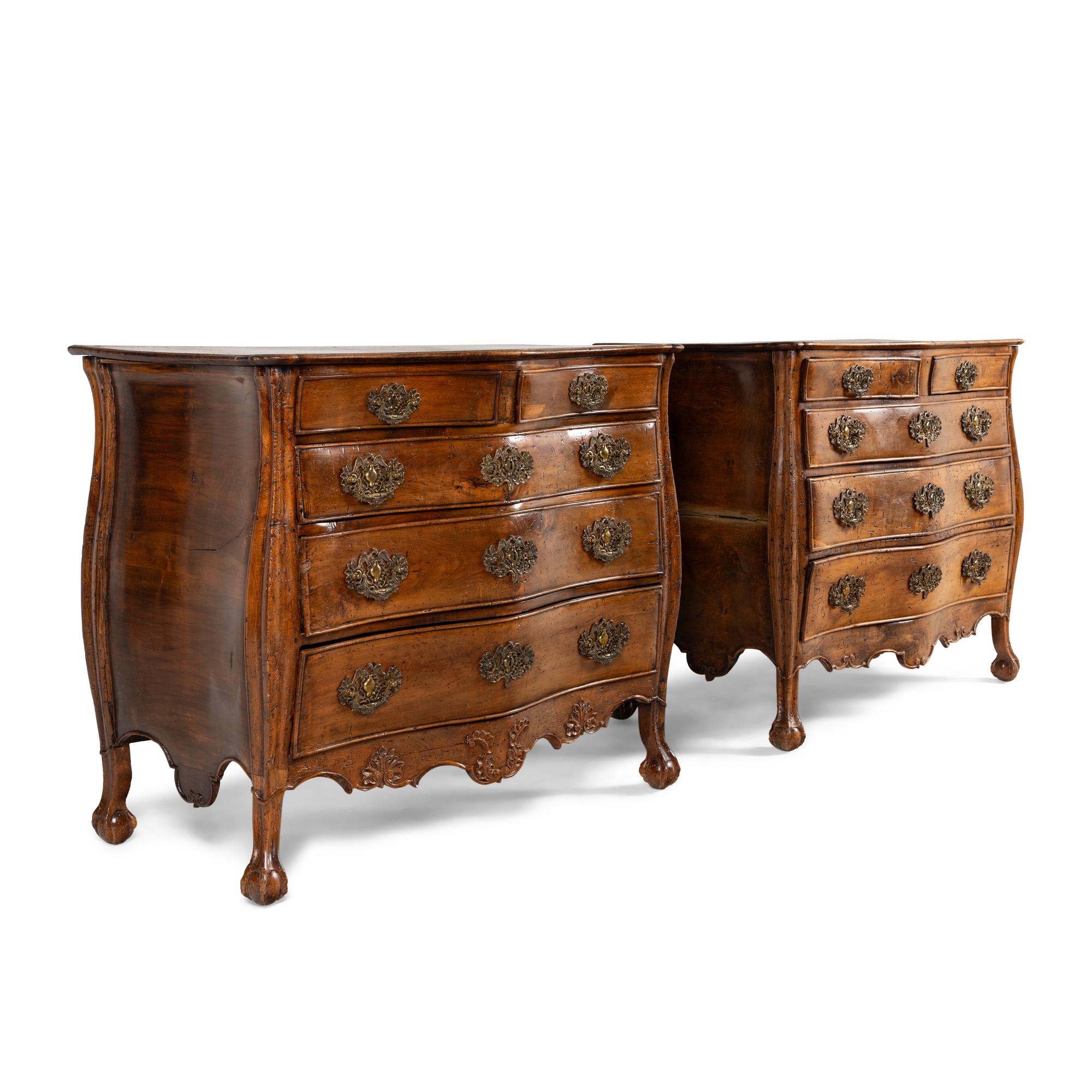 A Pair of Continental Walnut Chests of Drawers