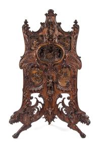 An Oversized Black Forest Carved Walnut Firescreen, Height 67 1/2 inches.