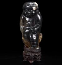 An unusual Chinese dark brown-black jade carving of a Lohan 笑狮罗汉玉雕 Ming dynasty or earlier ????