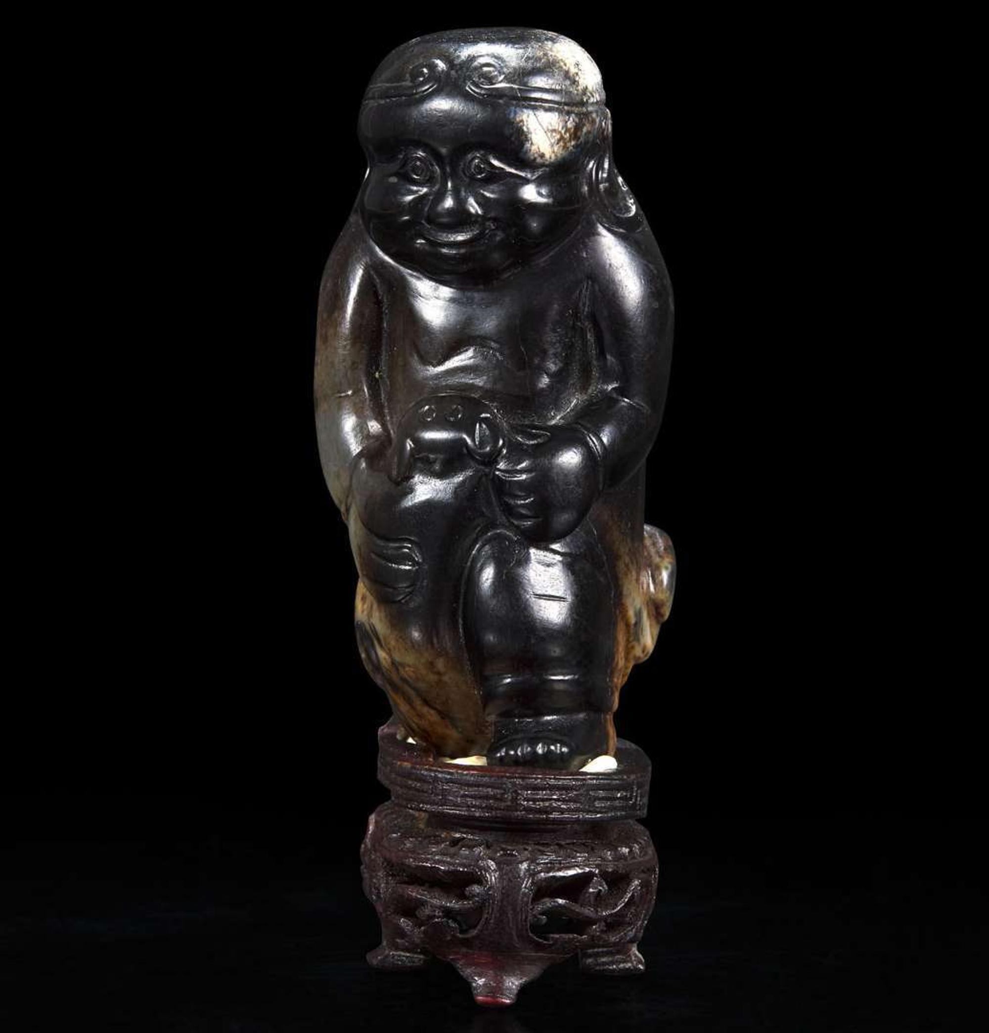 An unusual Chinese dark brown-black jade carving of a Lohan 笑狮罗汉玉雕 Ming dynasty or earlier ????