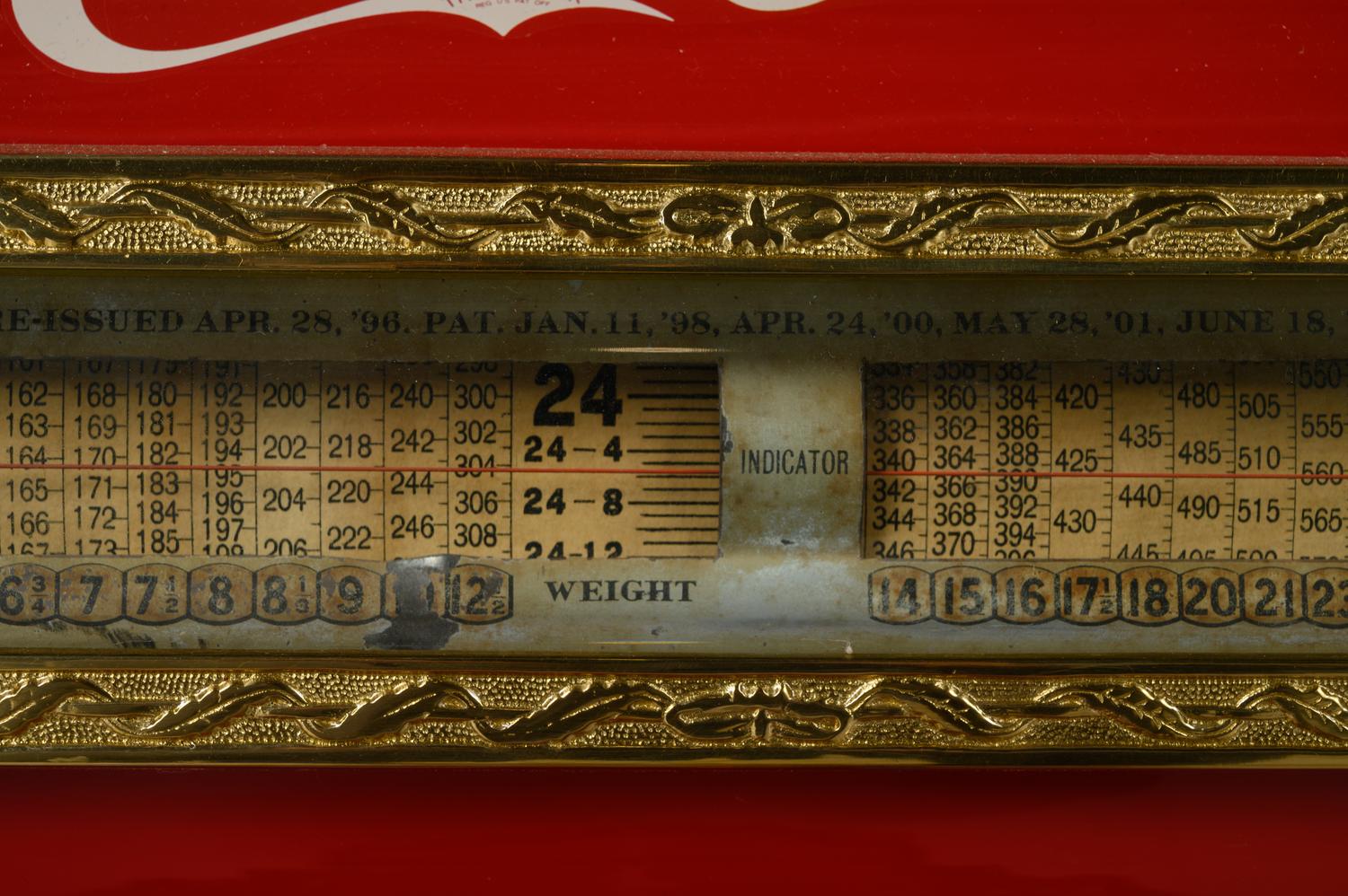 A Red Dayton Computing Scale with Coca-Cola Advertisement