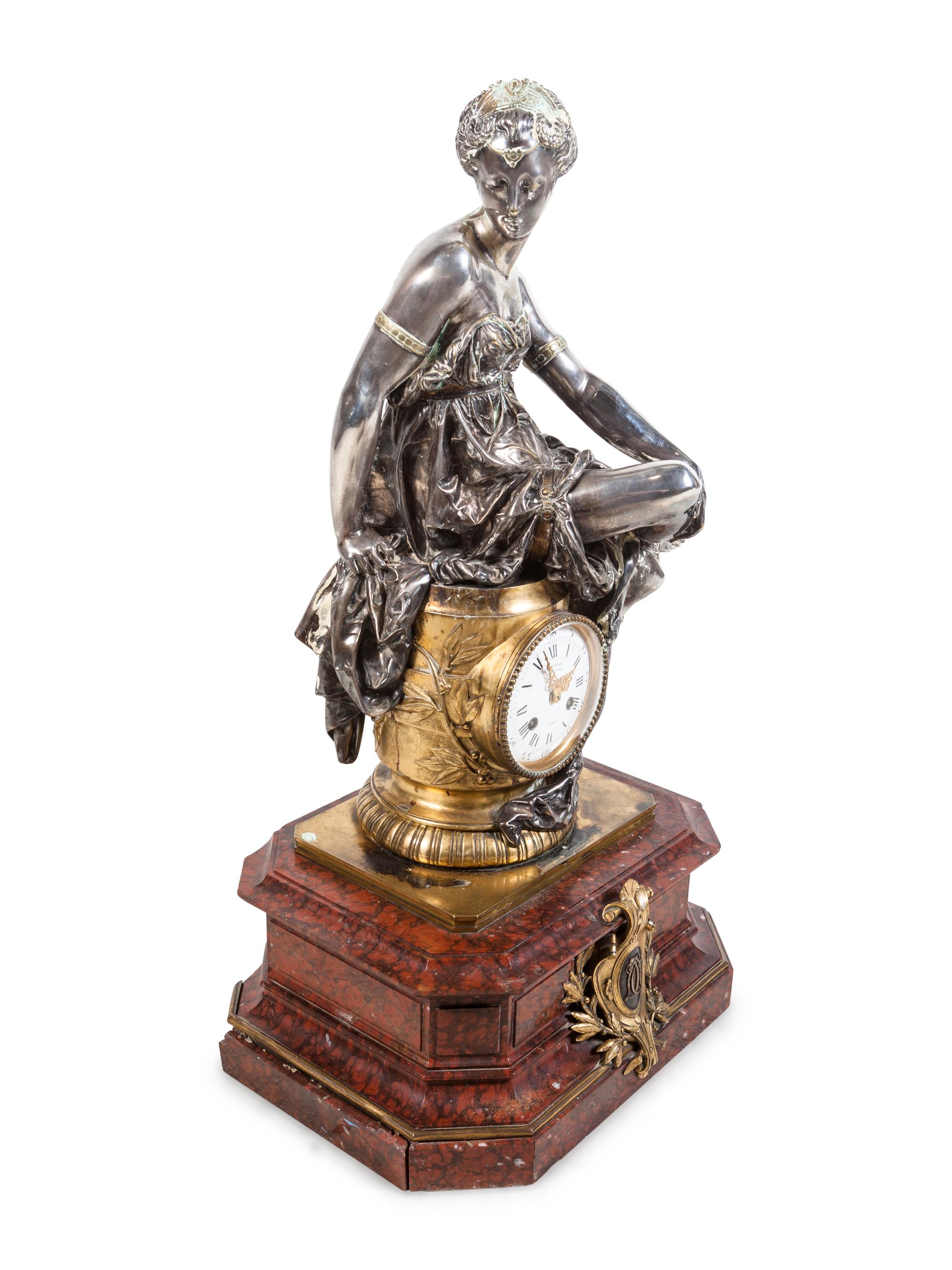 A Napoleon III Gilt and Silvered Bronze and Rouge Griotte Marble Figural Clock