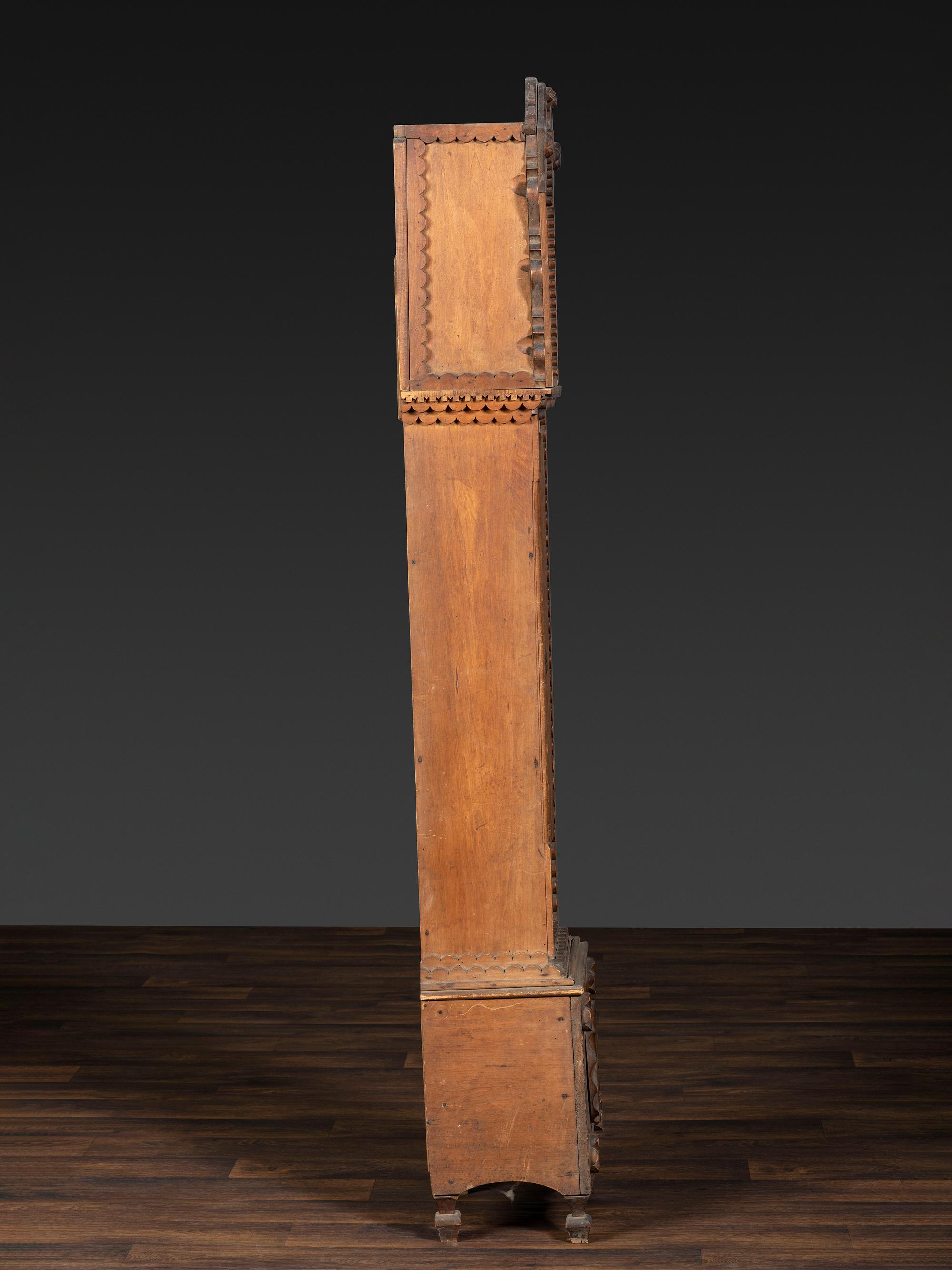 A Folk Art Carved Maple Clock Case